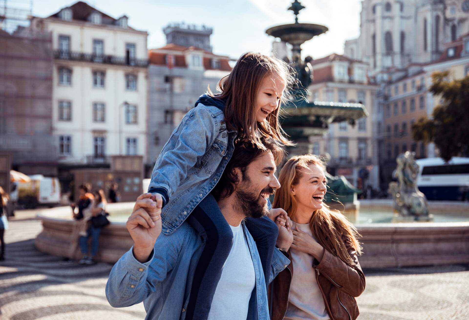 Close up of a young happy family exploring the Rossio Square