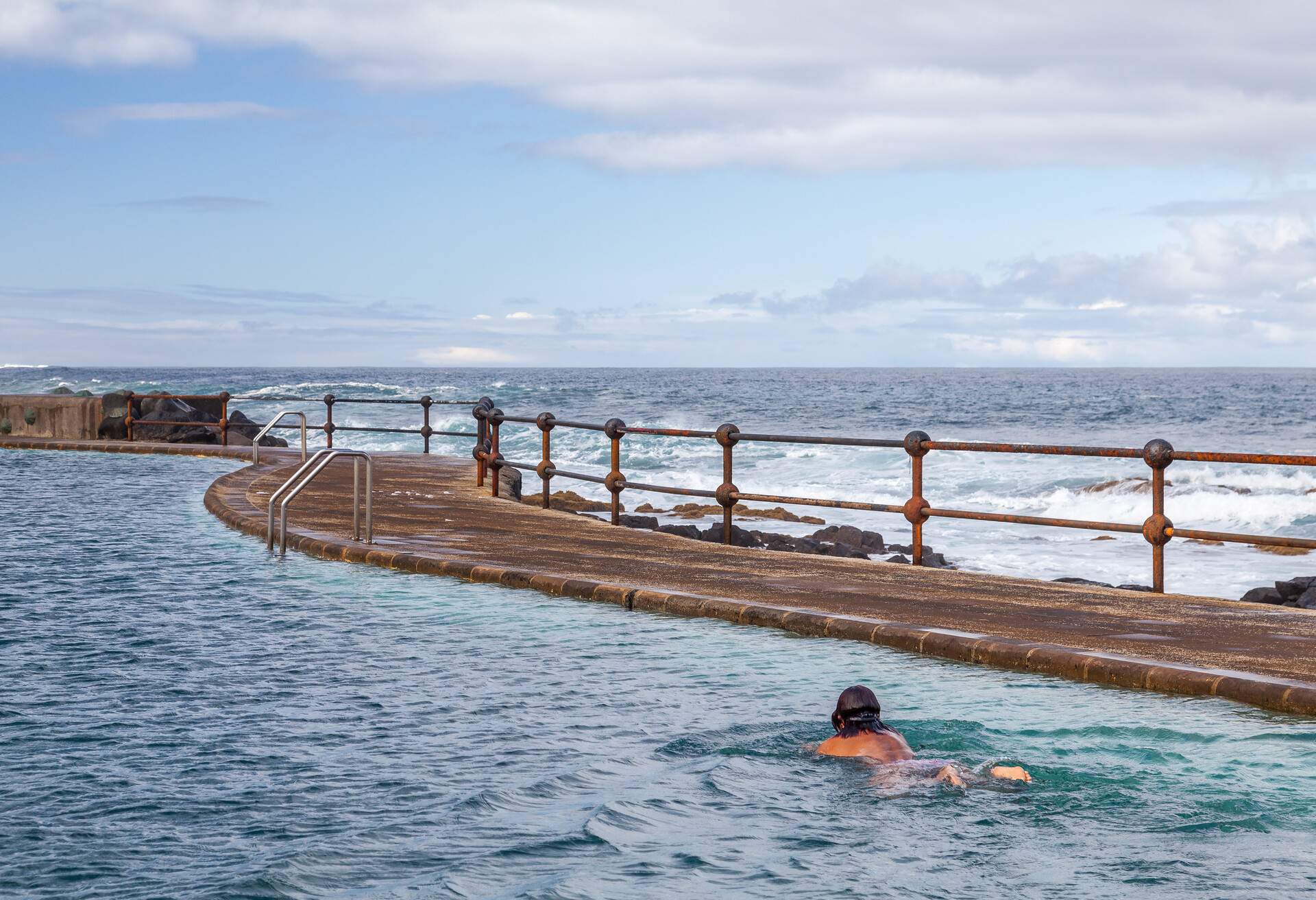 Senior adult swimming on a pool by the sea, Bajamar, Tenerife, Canary Islands, Spain