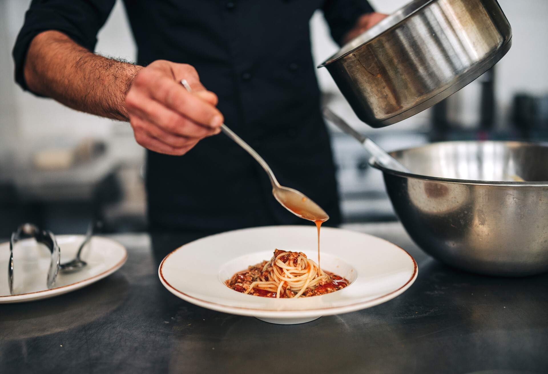 Professional Male chef hand prepare fresh pasta in commercial kitchen