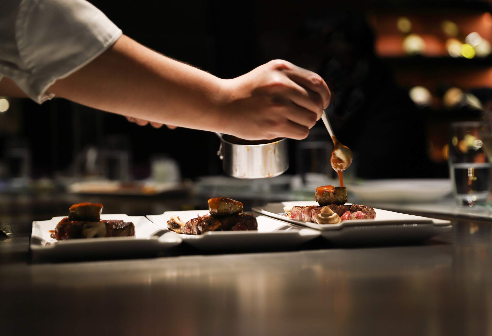 Teppanyaki chef cooking in front of guests.