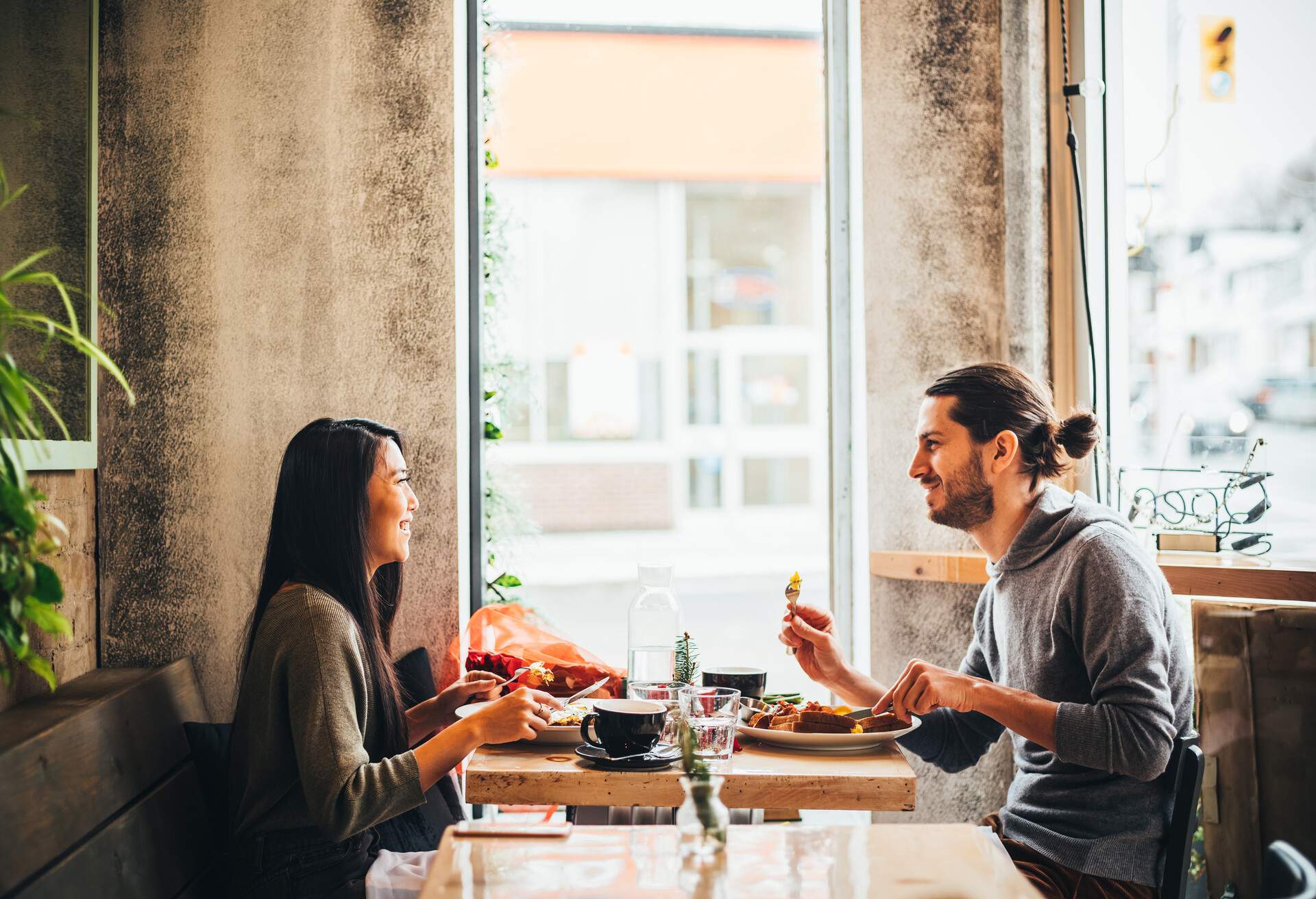 Young interracial couple on a date at the Bistro restaurant on Valentine's Day holiday.