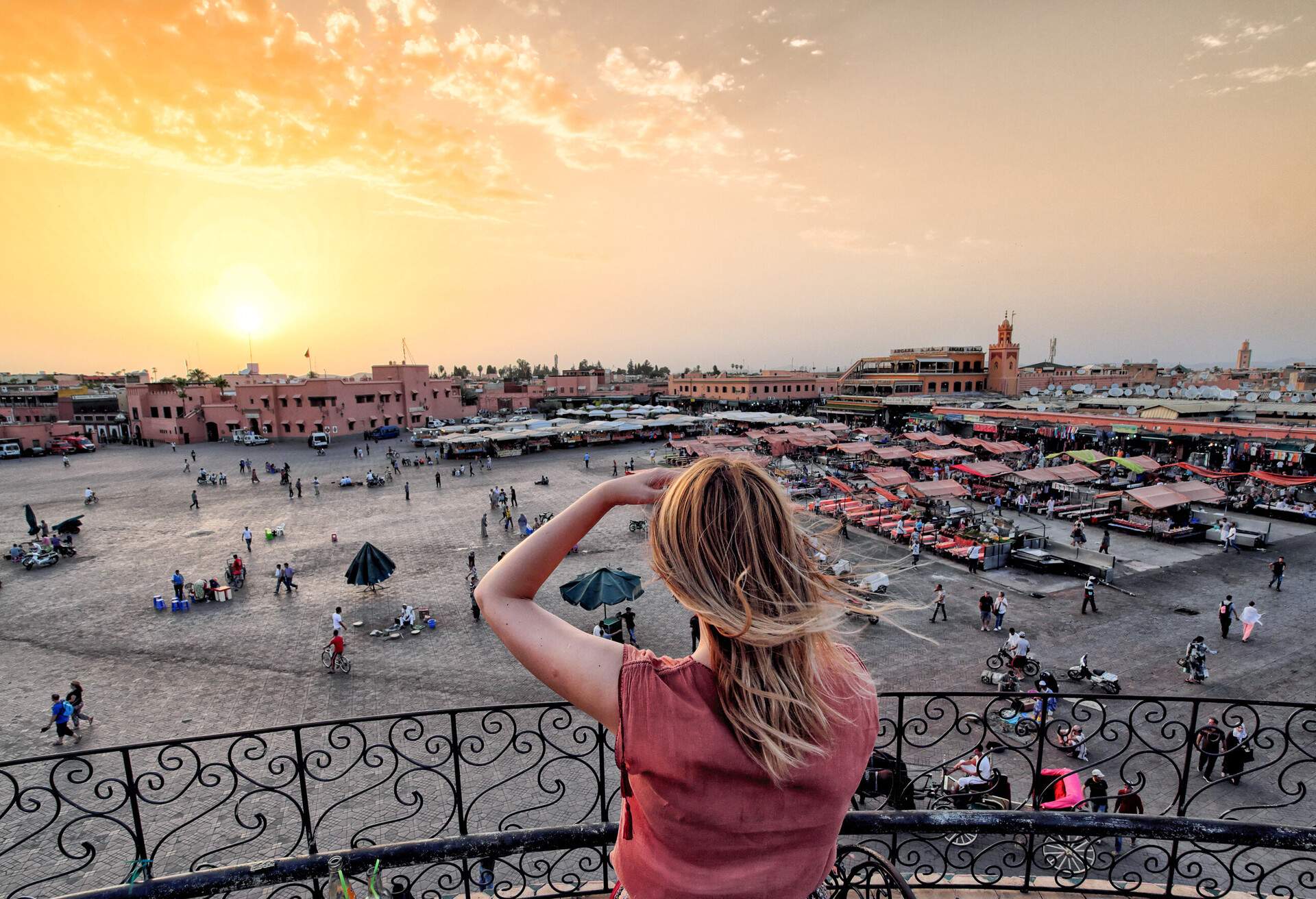 Jamaa el-Fna market Marrakech at sunset. Tourist watching the shops in the old medina