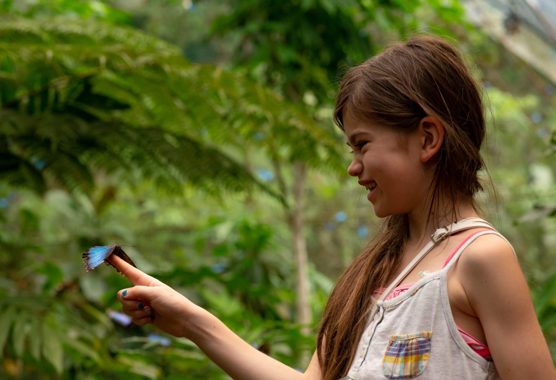 Girl holding a butterfly in Costa Rica