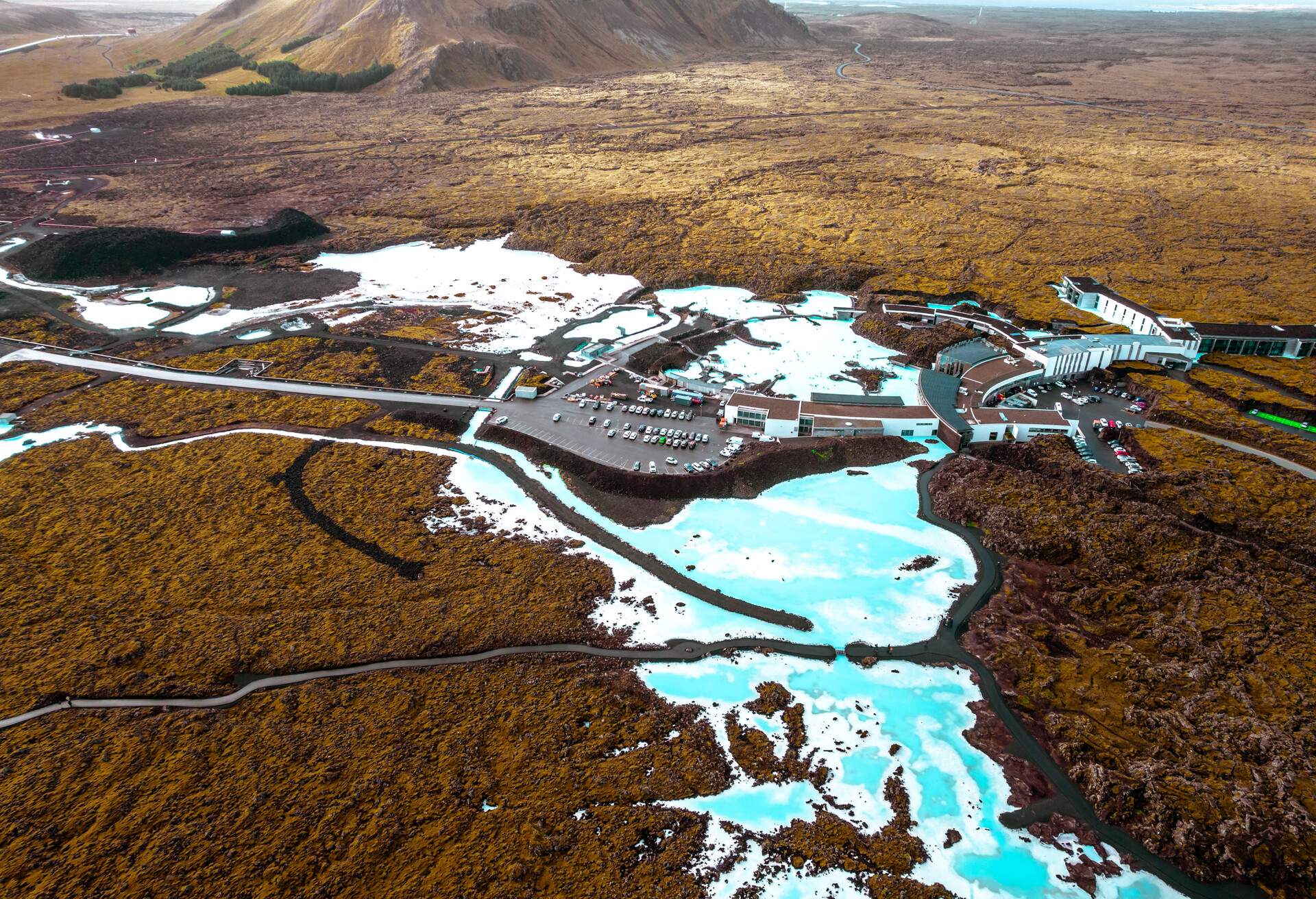 Aerial picture taken with drone flying above the Blue Lagoon using thermal water from the geothermal power plant for beauty spa and thermal pool.