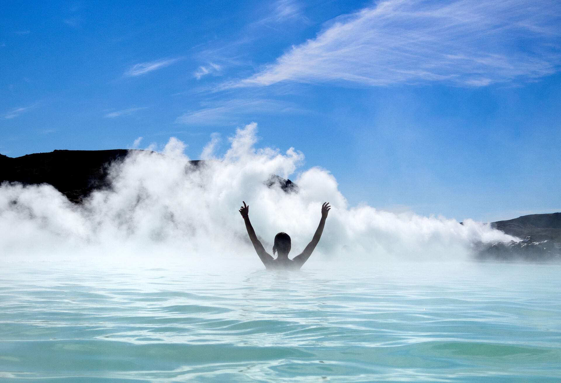 person enjoying the hot spring of blue lagoon on Iceland