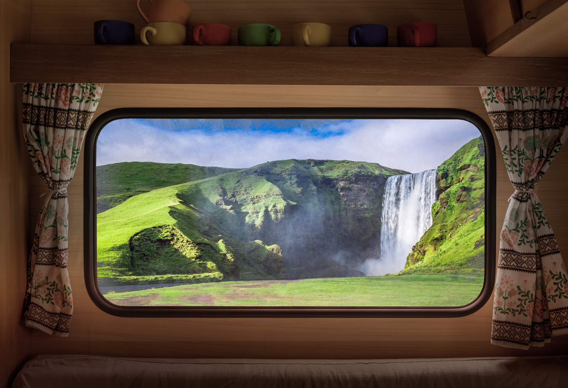 Spectacular Skogafoss waterfall in Iceland, view from camper window