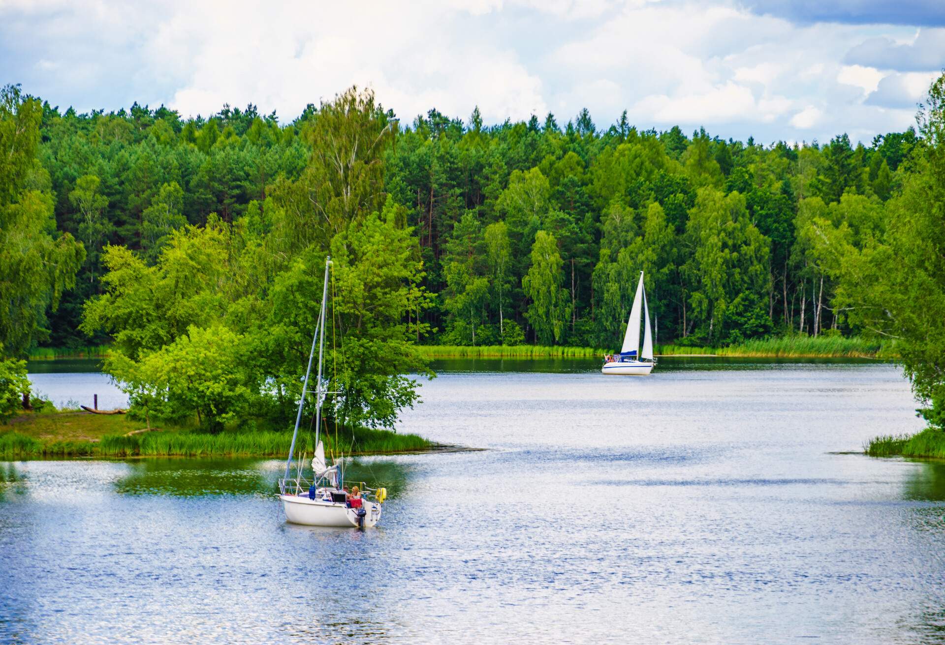 Boat yachts on lake during summer. Tuchola national park in Poland.