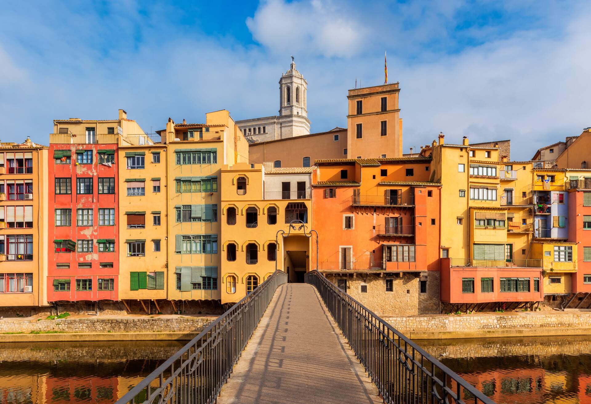 Bridge crossing River in Downtown Area of Gerona, Catalonia, Spain on sunny winter day.