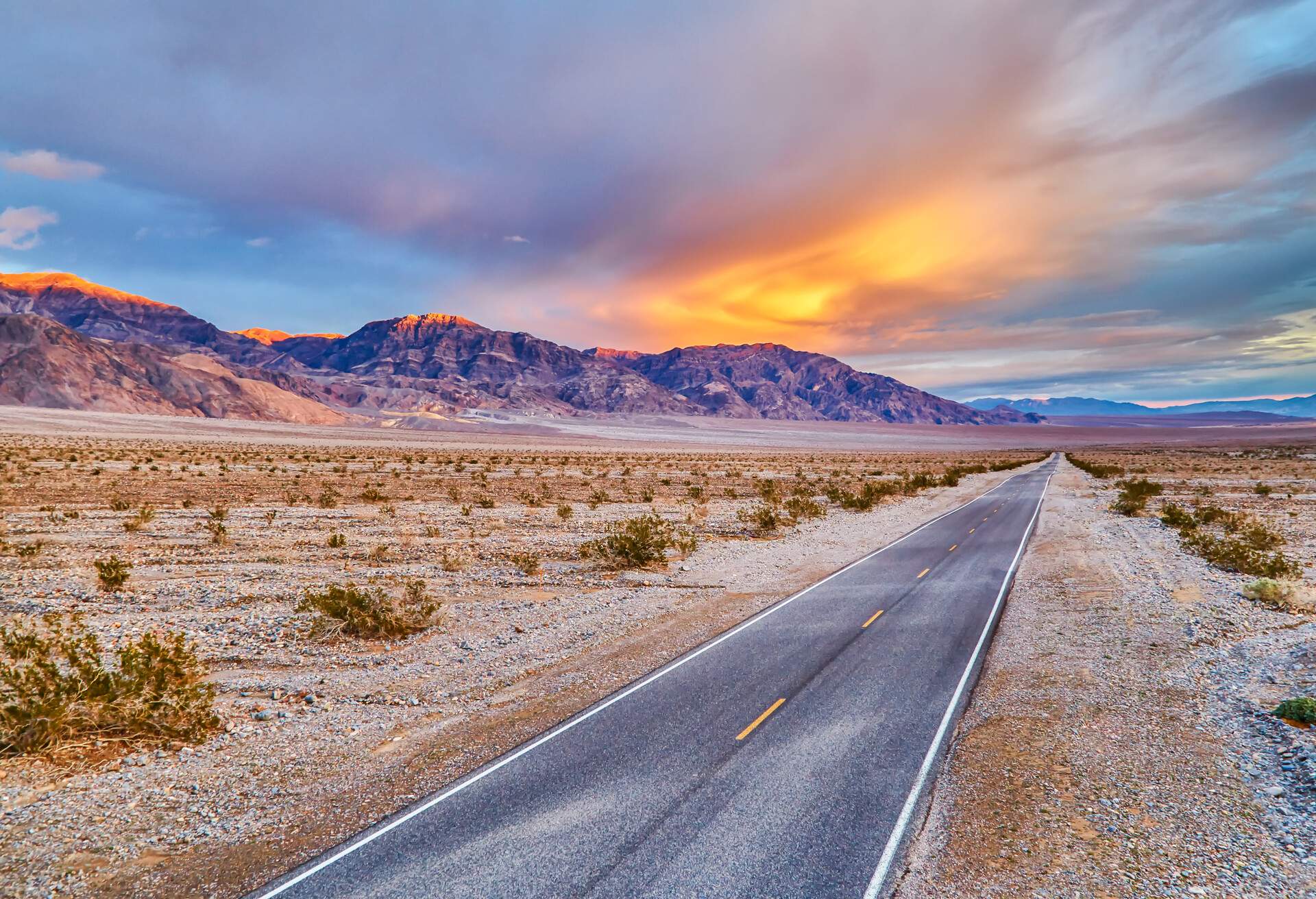 Long road through middle of desert at Death Valley National Park,California