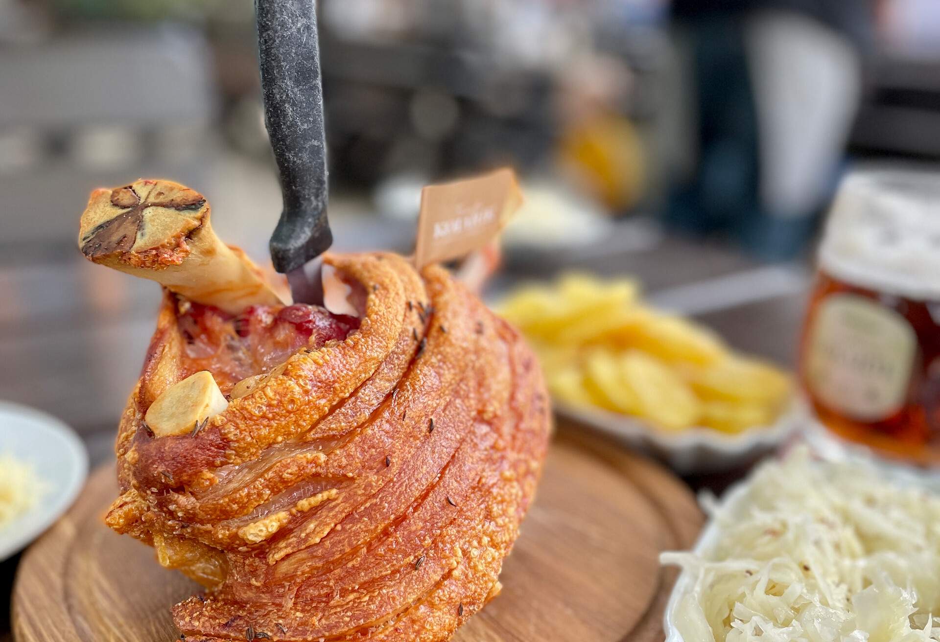 wooden plate with a typical Austrian speciality, knuckle of pork with coleslaw