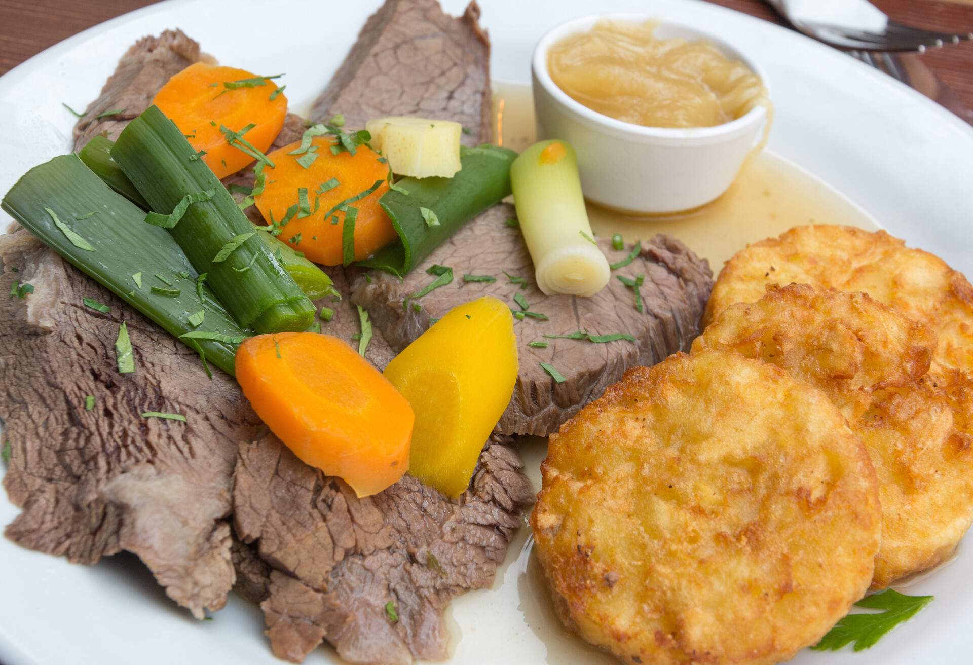 Tafelspitz (boiled filet of beef) with vegetables and fried potato cake, in Austria.
