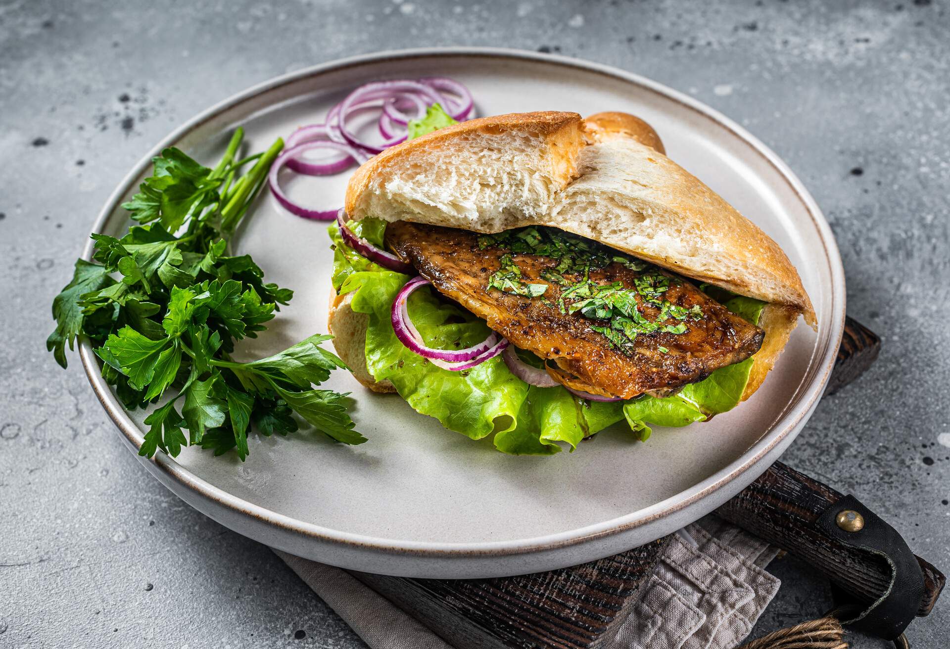 Balik Ekmek Turkish fish sandwich with grilled mackerel fillet in a bun.