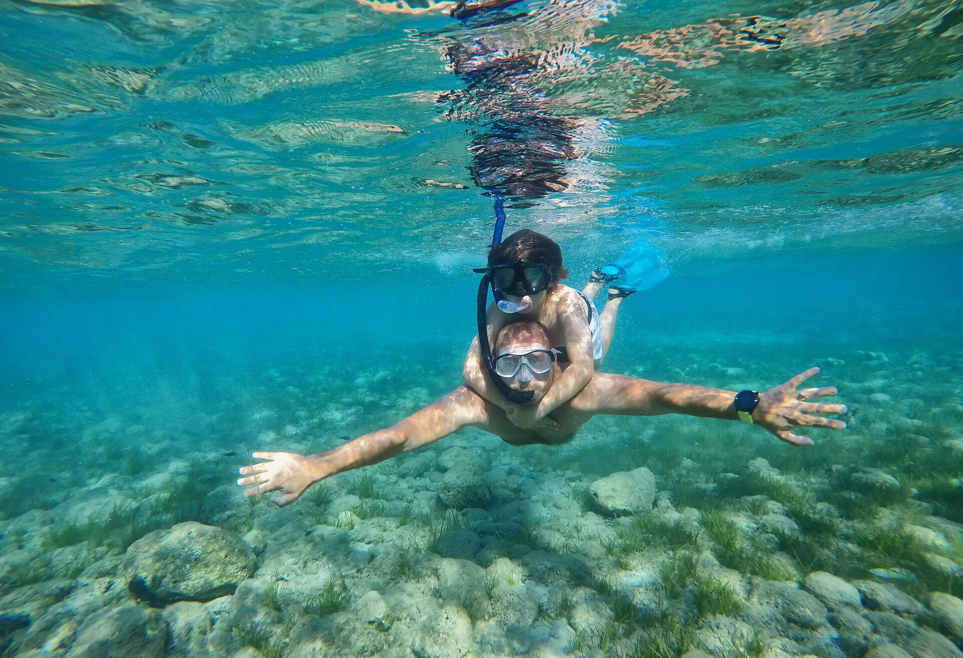 Underwater photo of father and son snorkeling