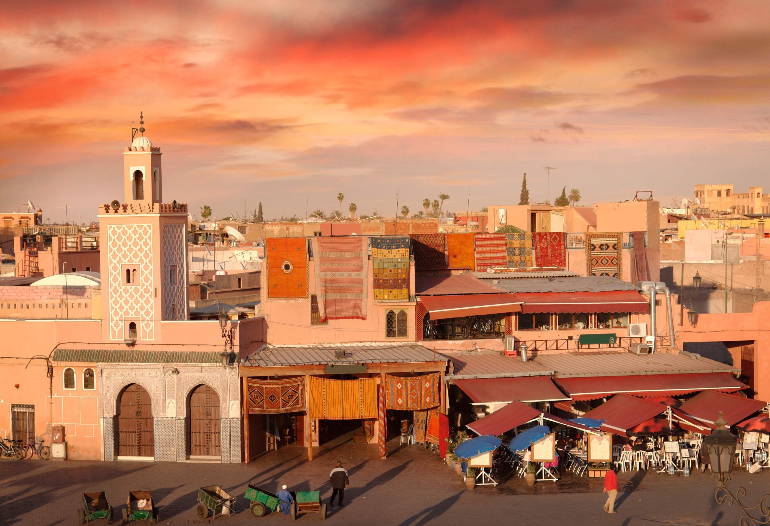 The iconic Djemaa el-Fna Square stands empty, bathed in the warm glow of the setting sun.