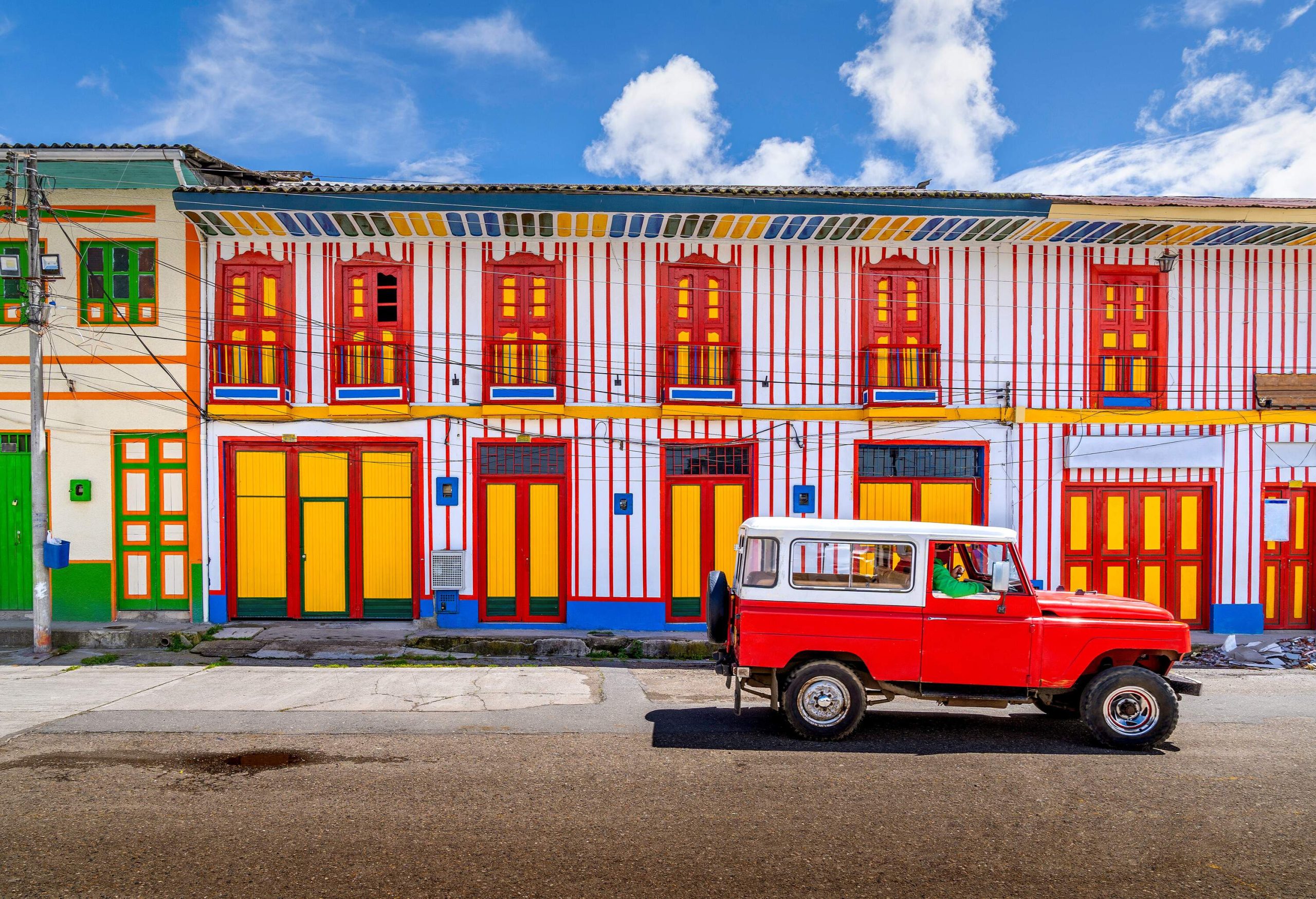 A car passing on the colourful street of Tolima Colombia the little town in a sunny day.