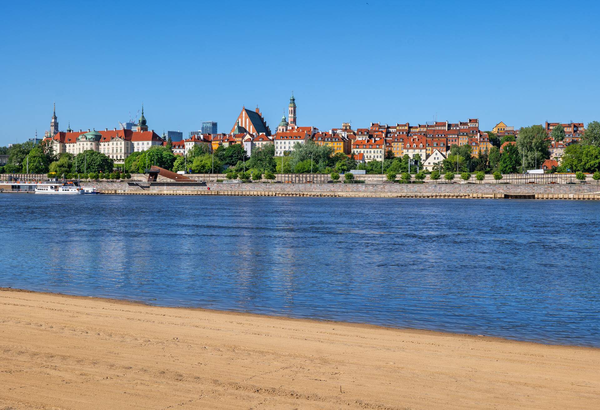 Beach at the Vistula river in city of Warsaw in Poland with view to the Old Town skyline.