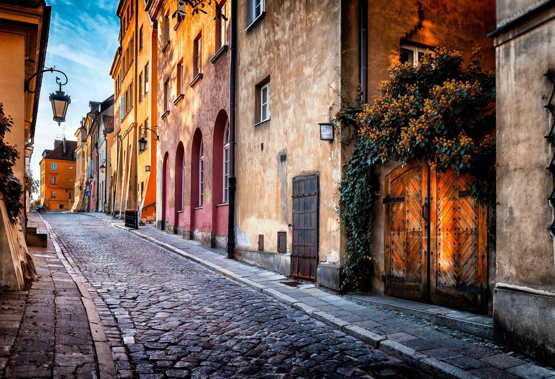 A narrow paved lane between old buildings in an old town.