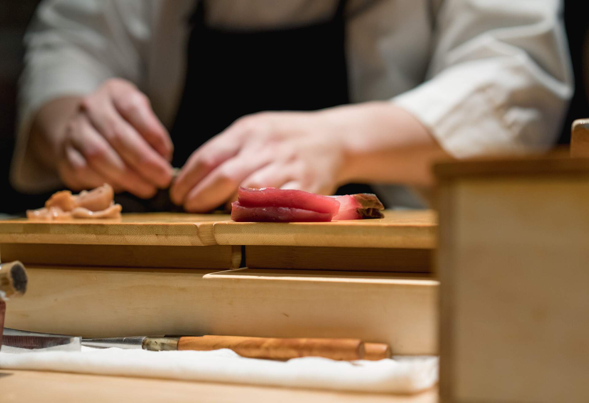 Sushi Master makes sushi at the bar
