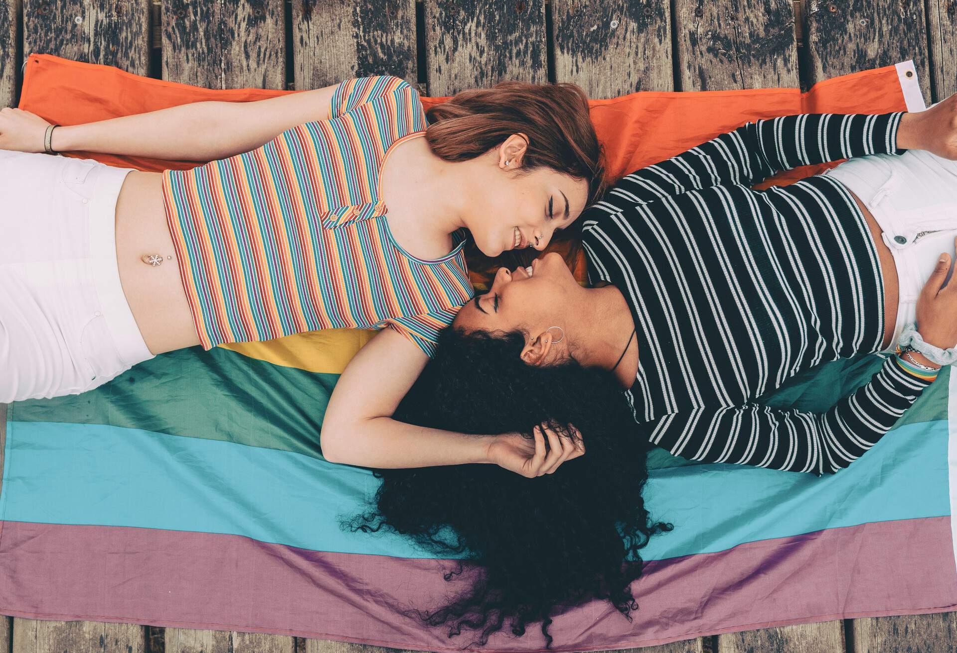 Cute lesbian couple lying together on the carpet