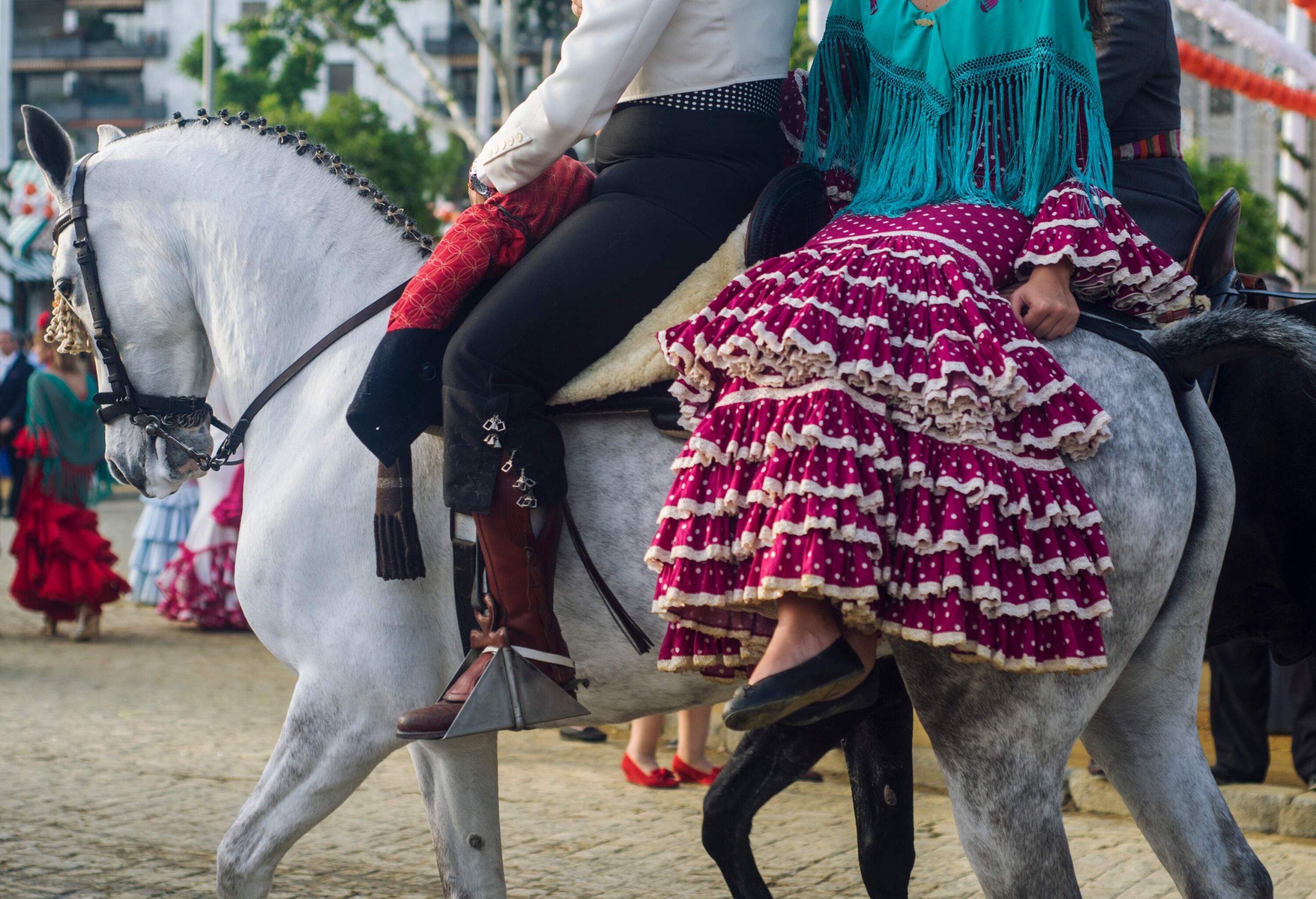 Couple riding on a white horse.