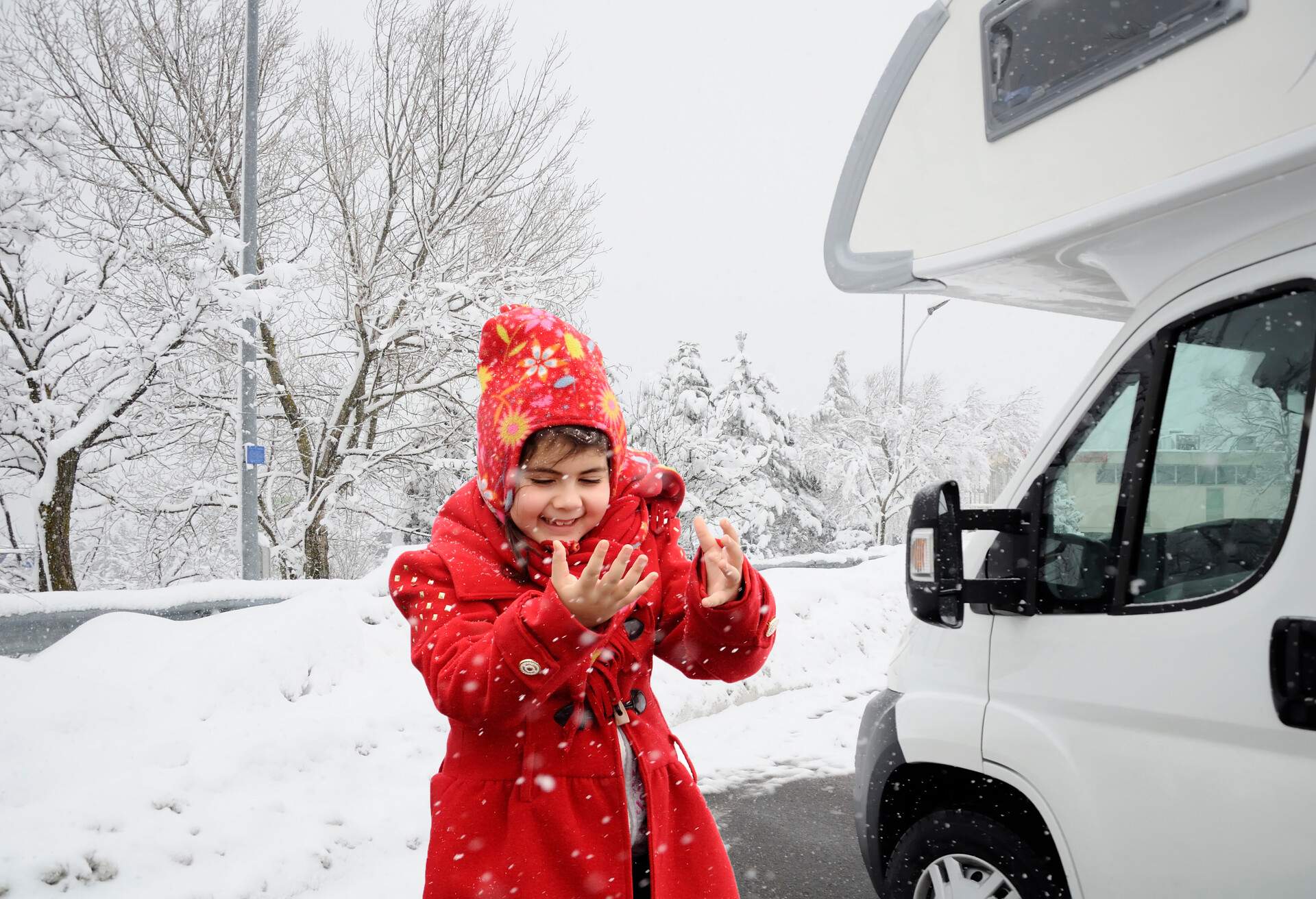 child and camper with snowy background 