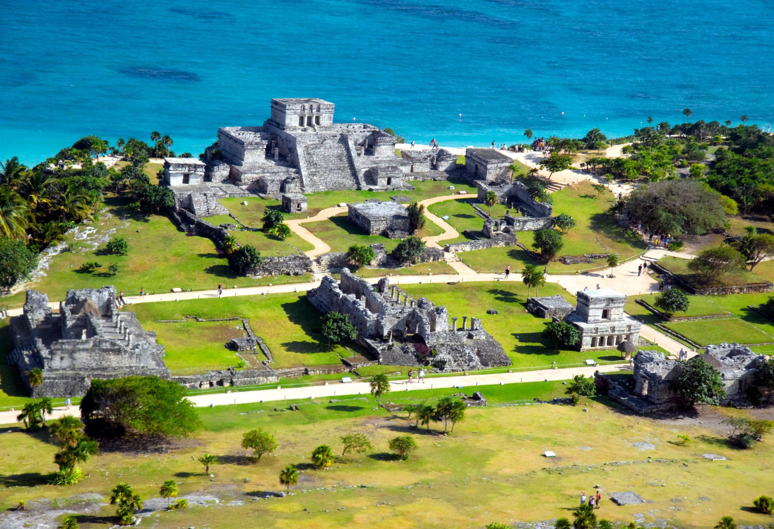 Tulum's Mayan port city ruins on the coast of a beautiful blue sea.