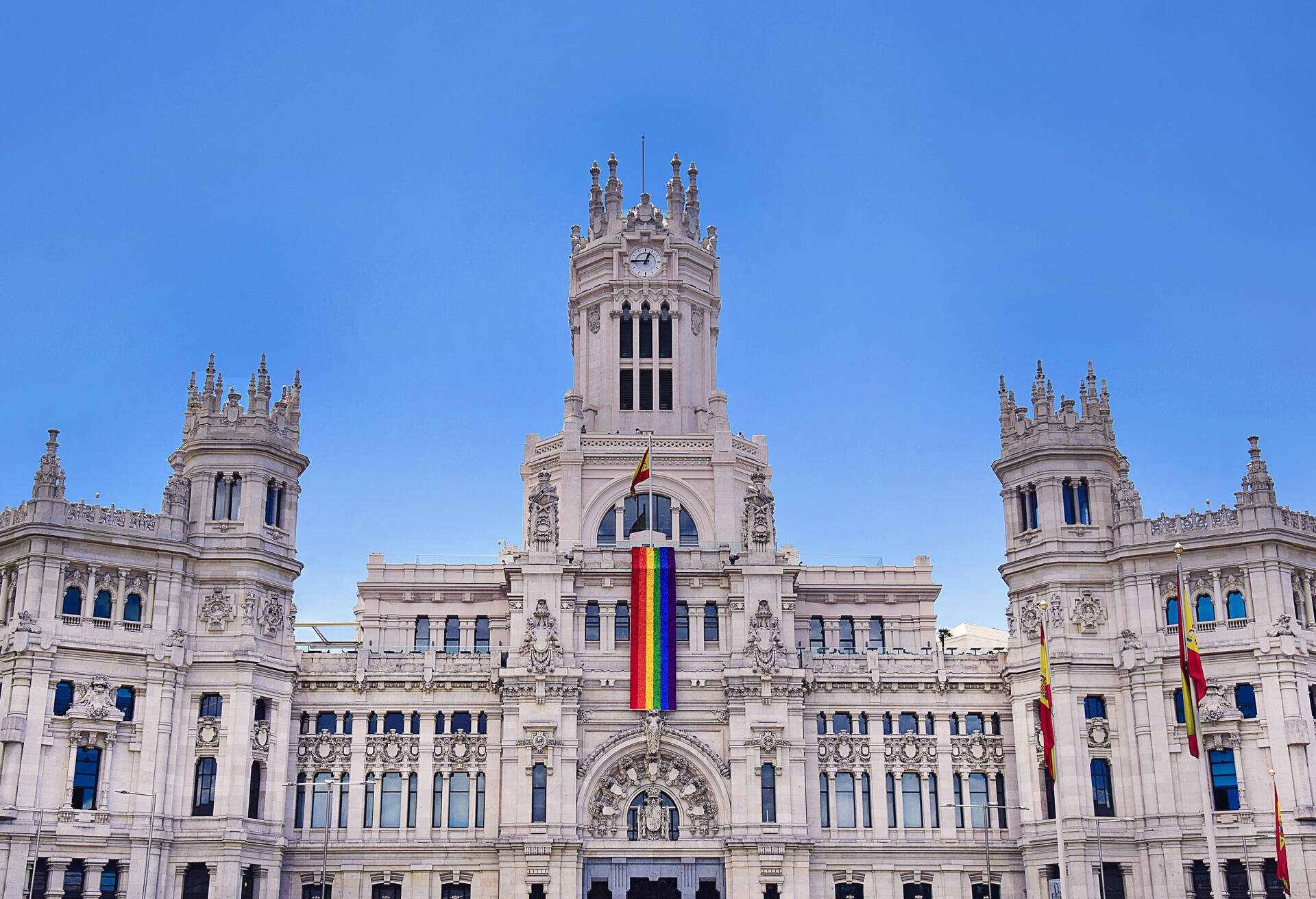 A pride flag draped down the center of Madrid's city hall, Spain
