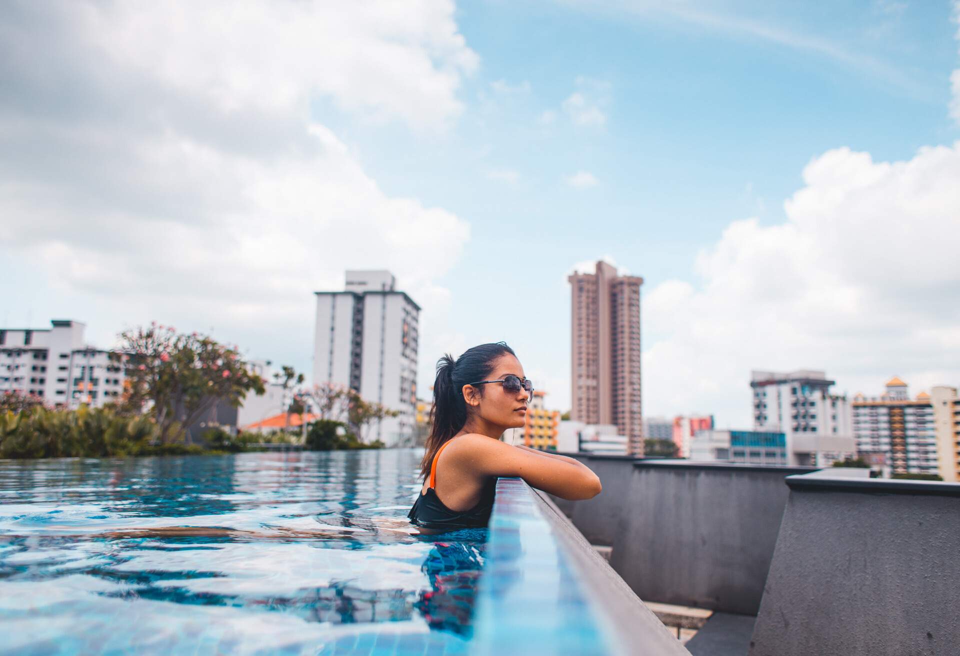 Woman in rooftop swimming pool of a hotel