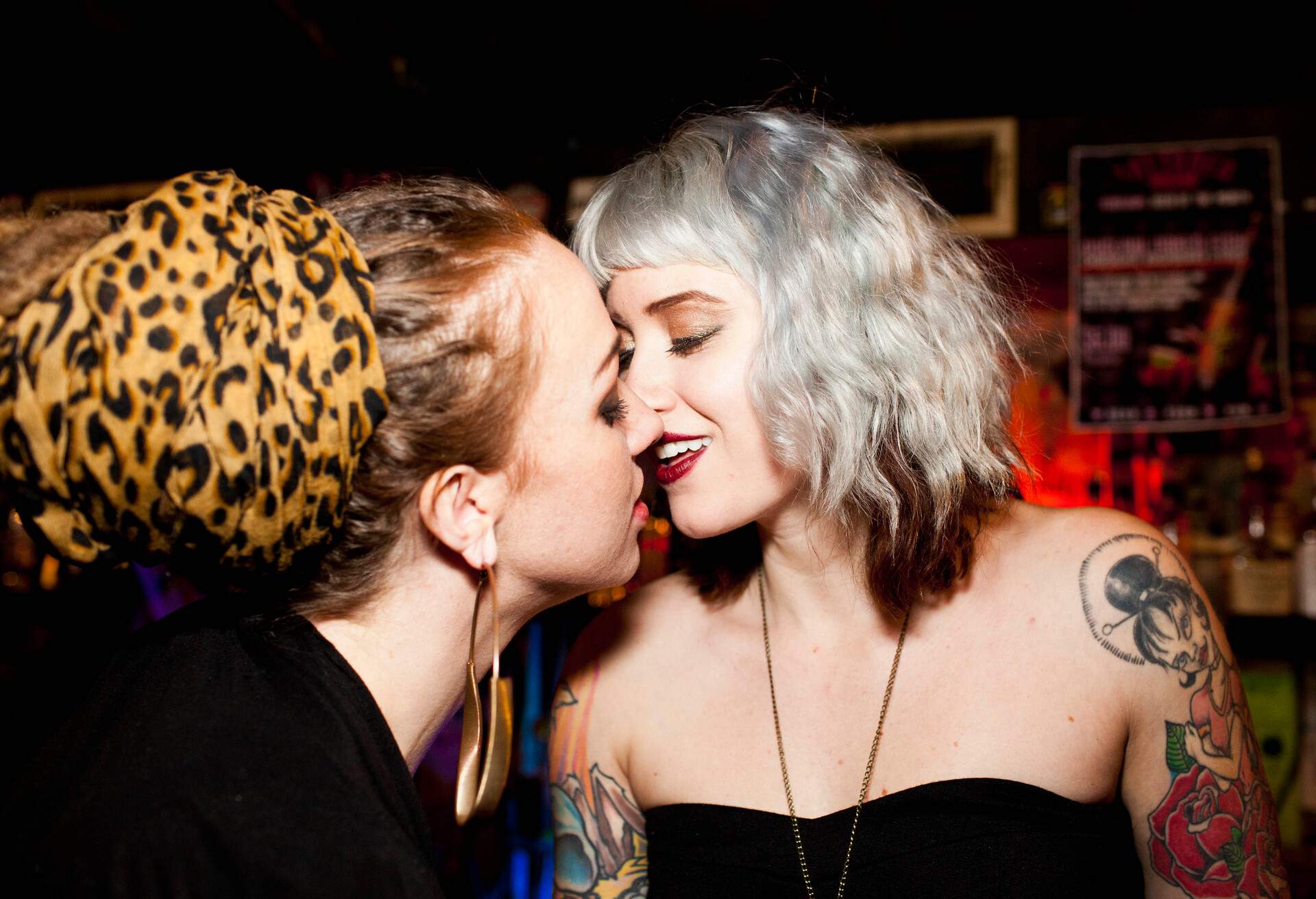 A female couple kissing inside a bar, LGBTQ nightlife