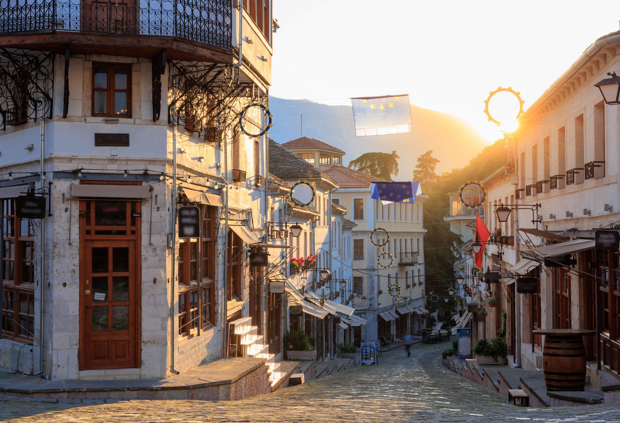 An atmospheric old street, lined with characterful buildings housing quaint shops.