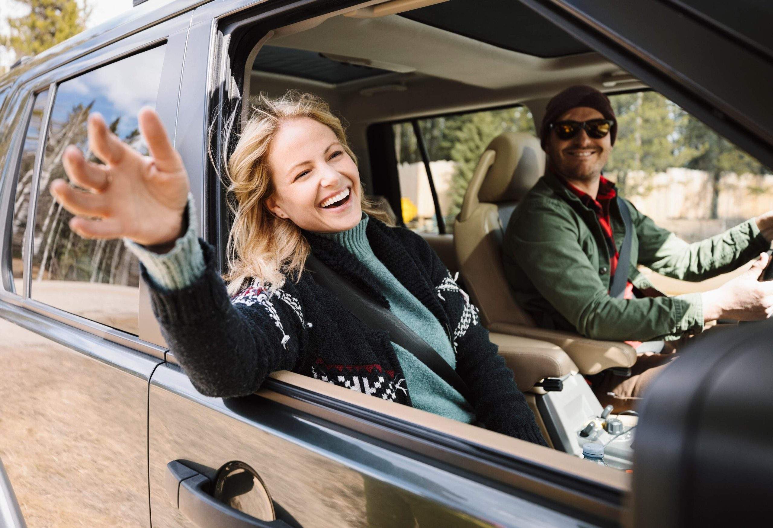 theme_car_couple_woman_happy_gettyimages-1149890083-scaled