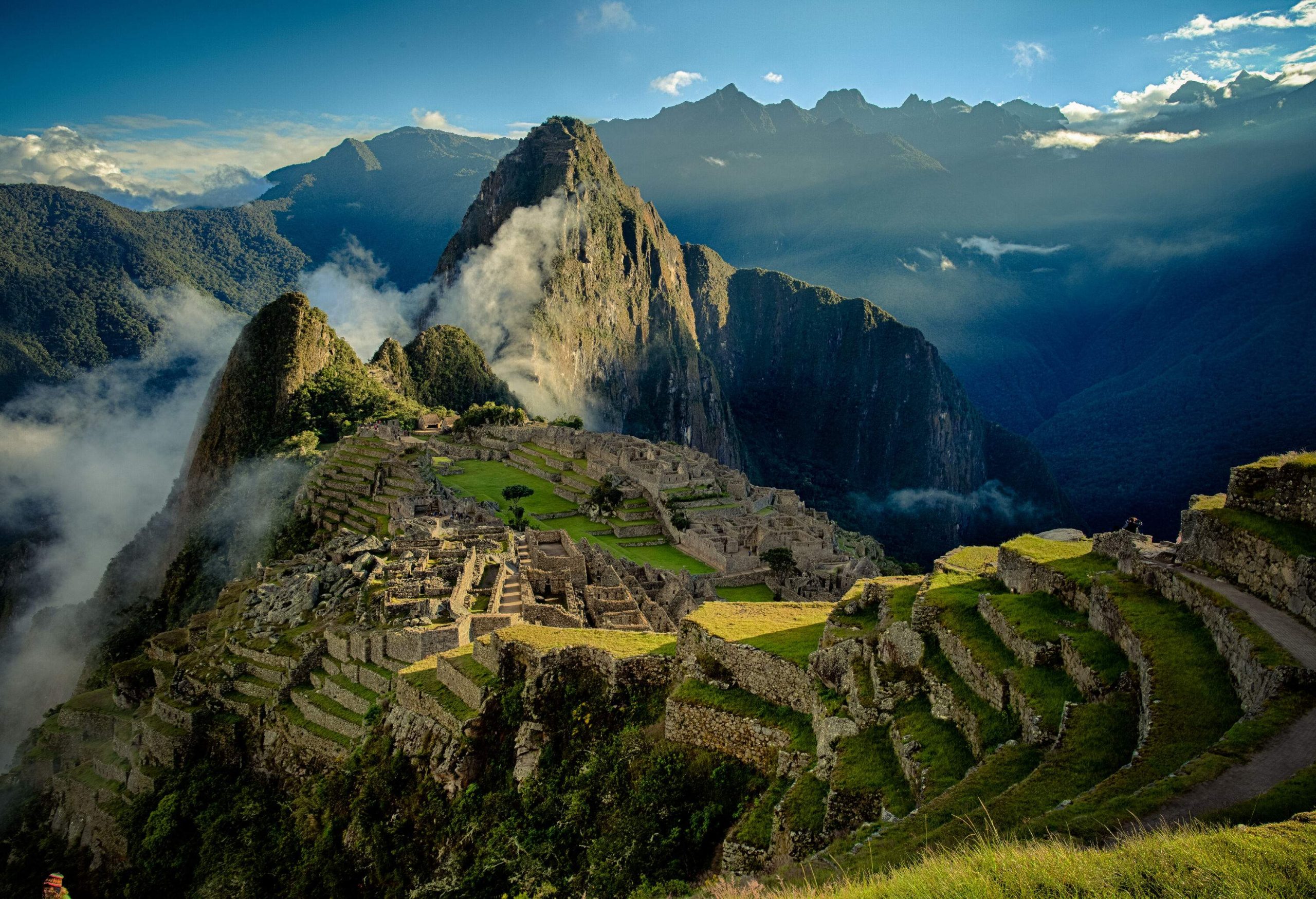Machu Picchu is an ancient settlement on top of the mountains shrouded in fog.