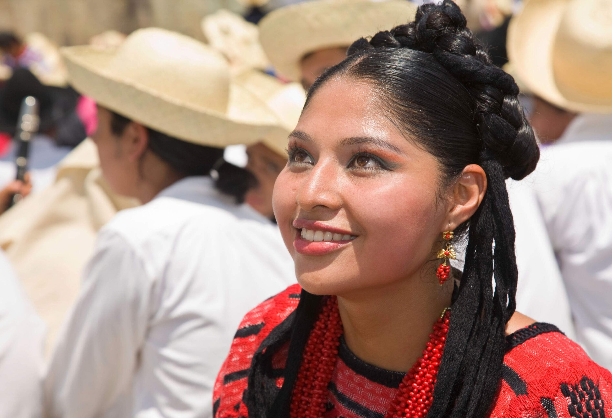 Portrait of a smiling woman in a traditional red dress.