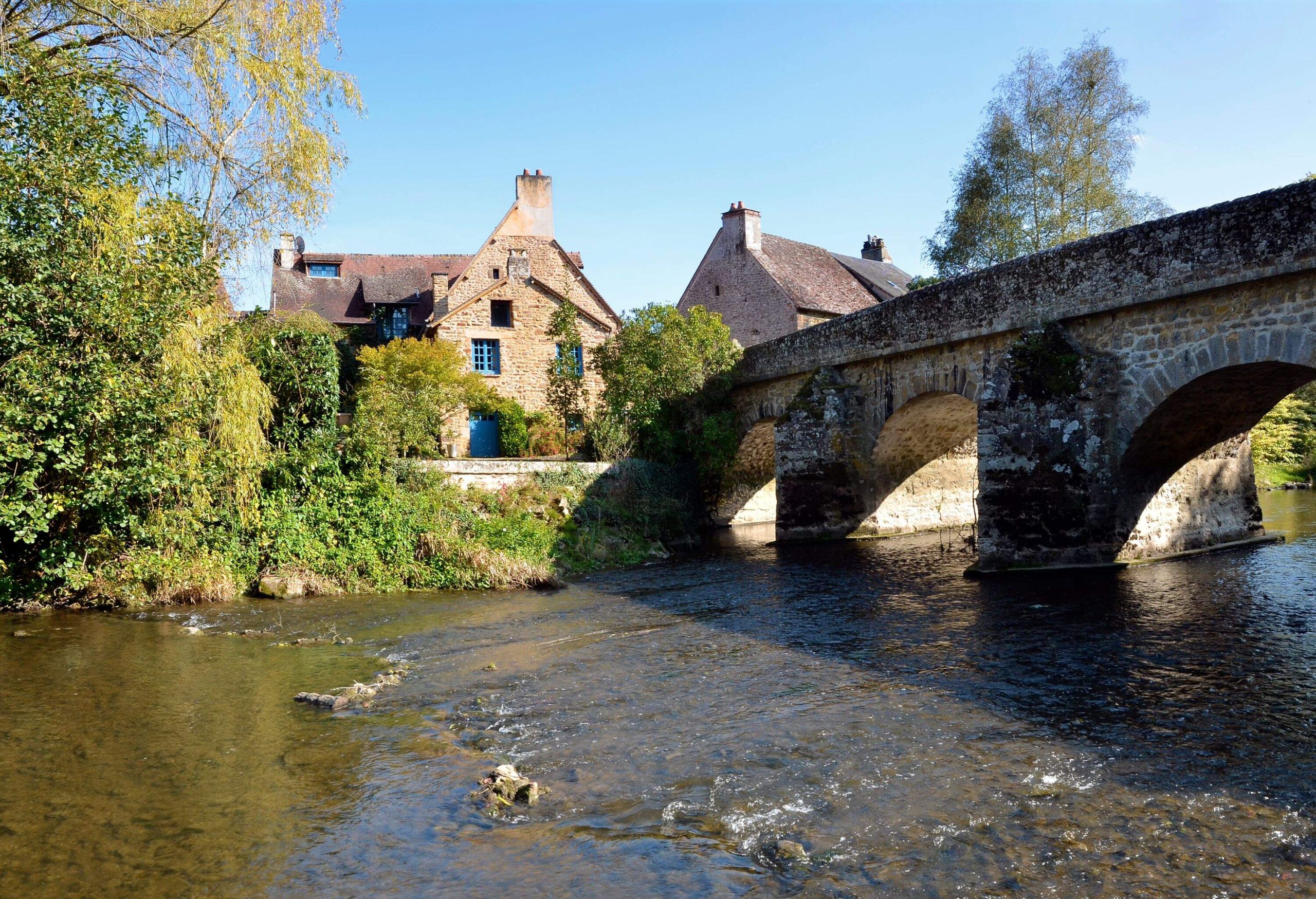 Panoramic the river Sarthe and old bridge of village Saint-Céneri-le-Gérei (“France’s Most Beautiful Villages”) ,department of the Orne, region Basse Normandie in France