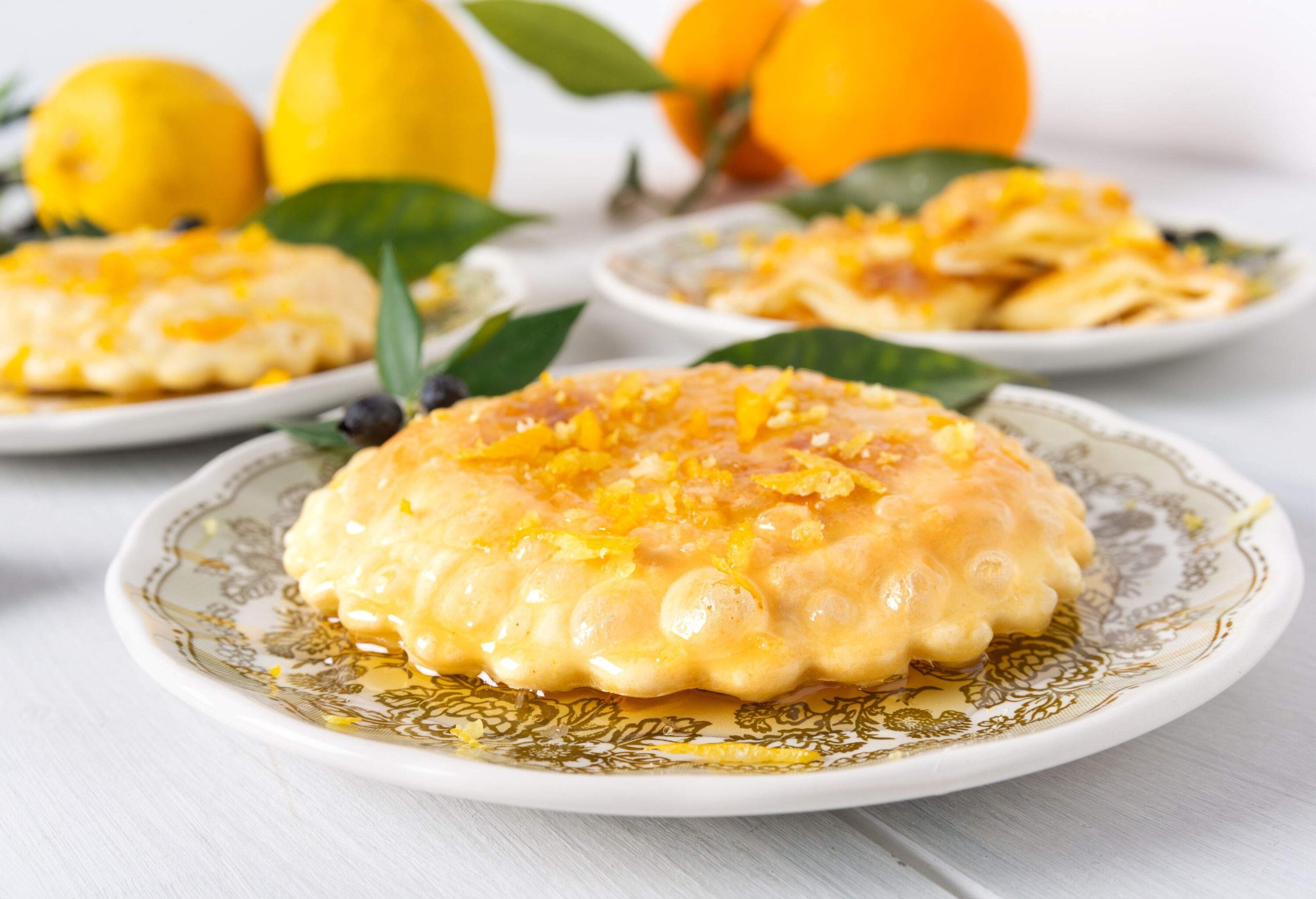 A round deep-fried pastry topped with cheese and drenched in syrup.