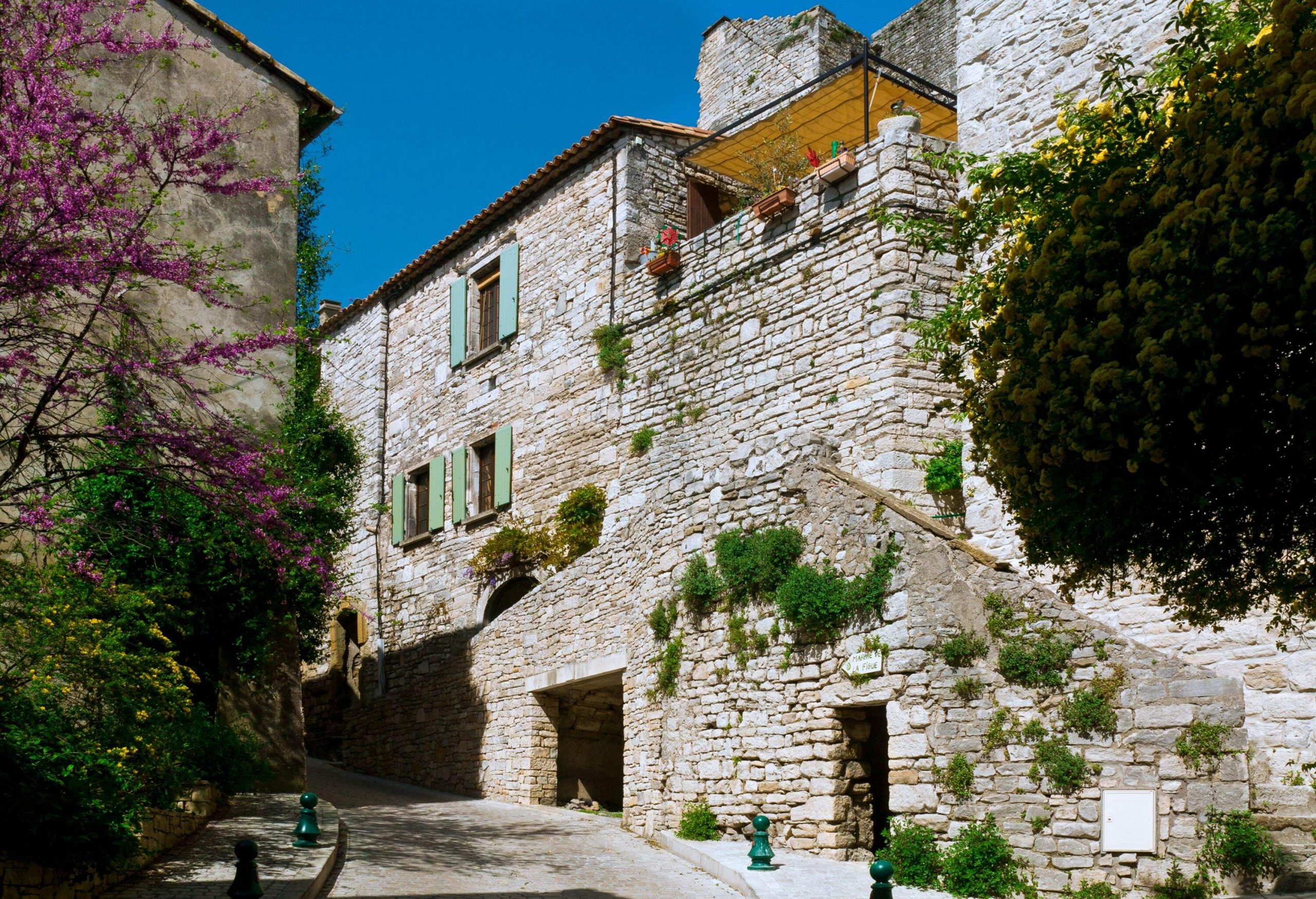 narrow streets in the village . Houses built  with dry stones