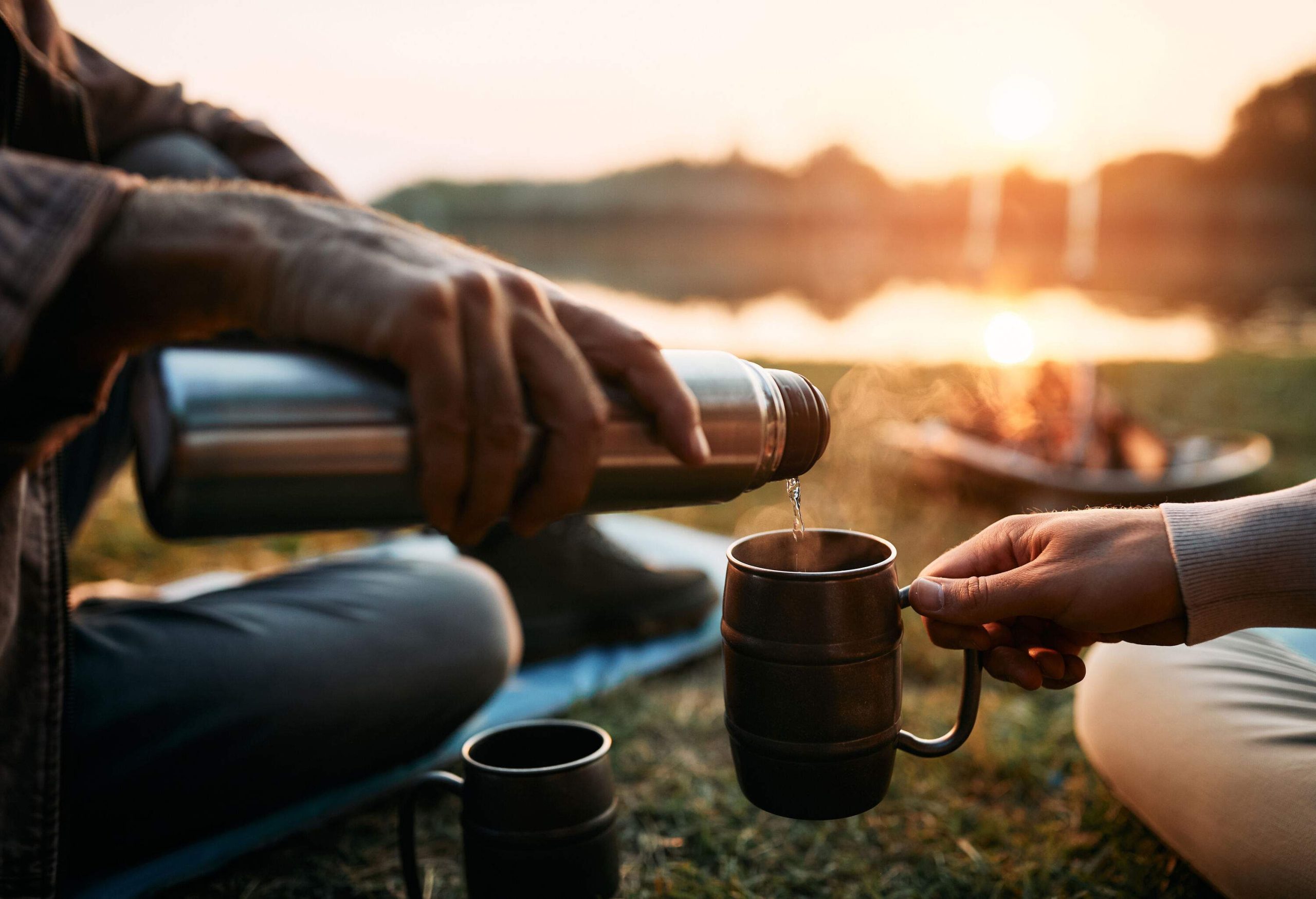 A man filling another person's cup with water.