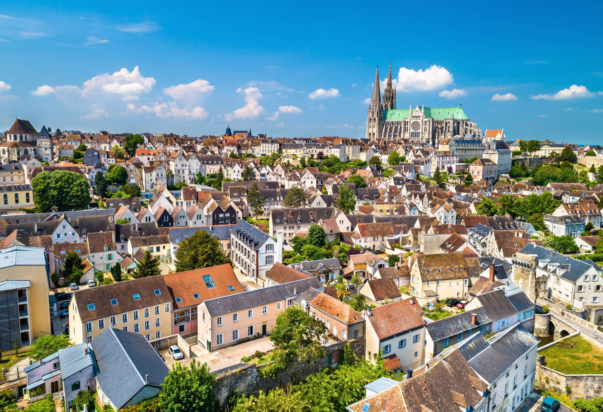 An historic town with a spired church in the backdrop.