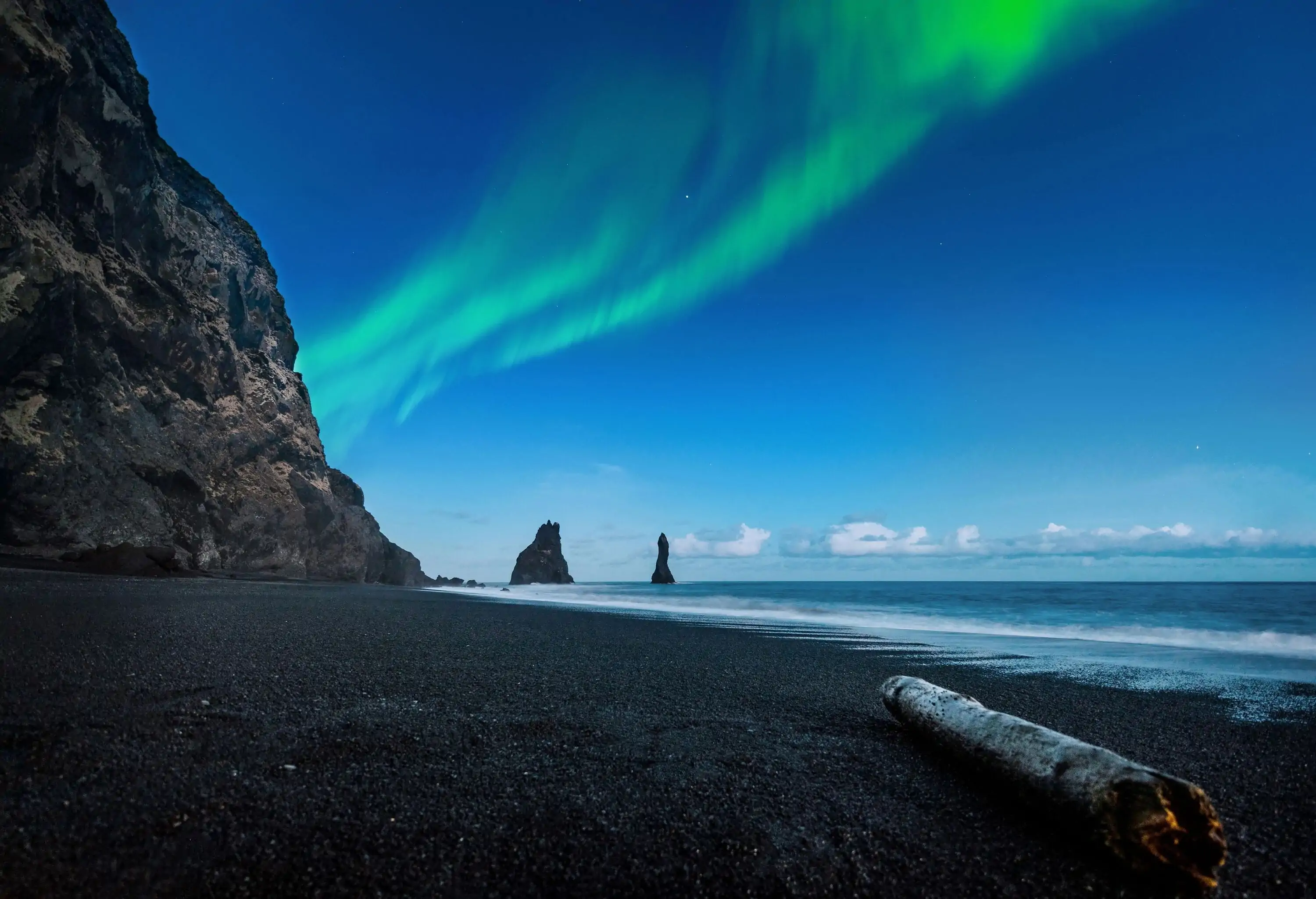 Northern lights above an icelandic beach in Vik at Iceland.
