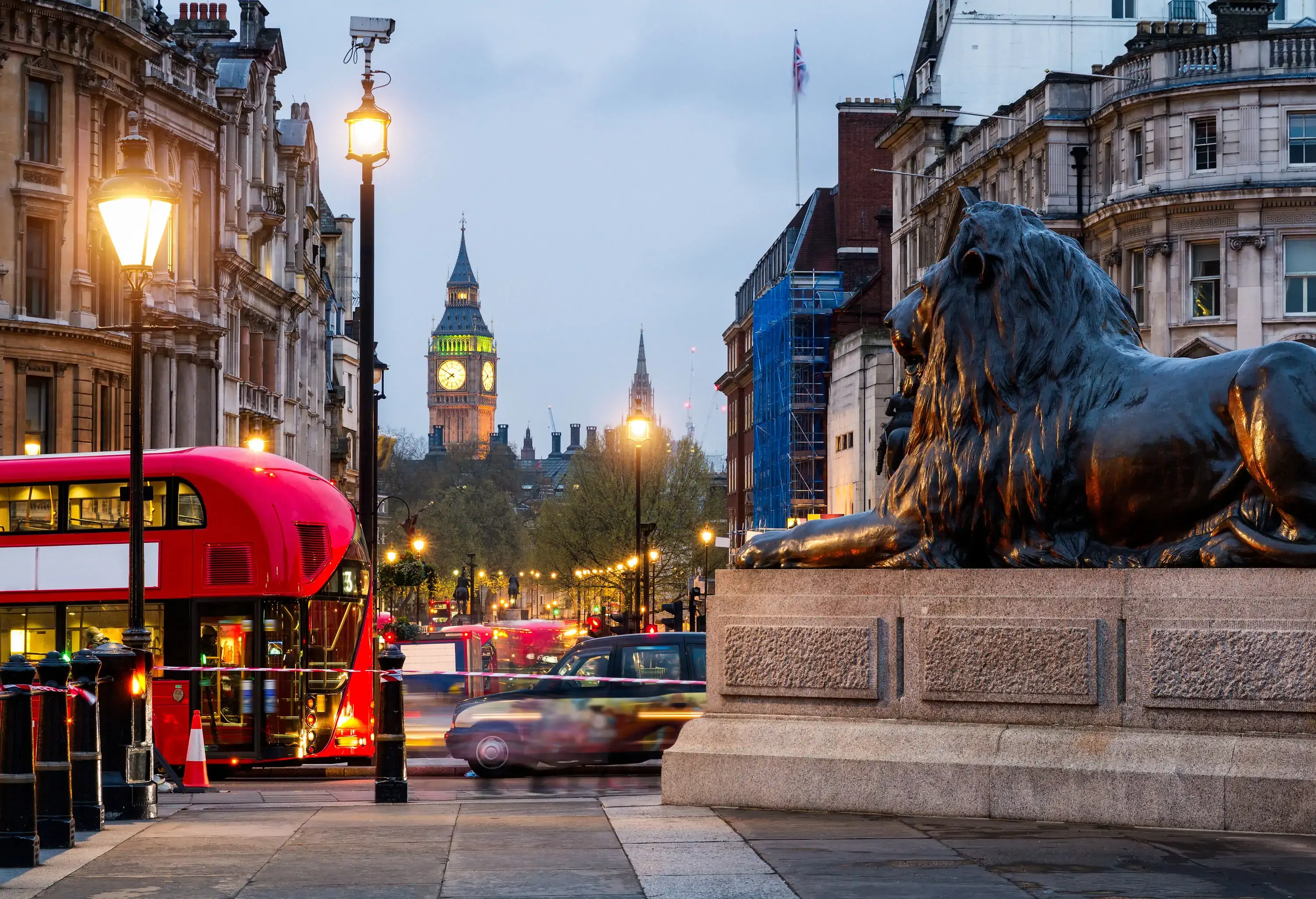 Street view of Trafalgar Square towards Big Ben at night in London, UK