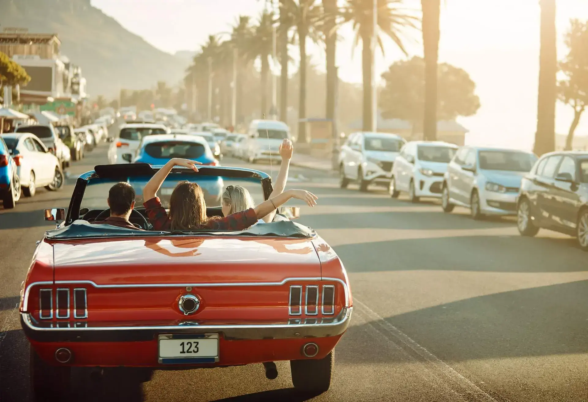THEME_CAR_VEHICLE_CONVERTIBLE_SUNSET_PEOPLE_VACATION-GettyImages-1148606069