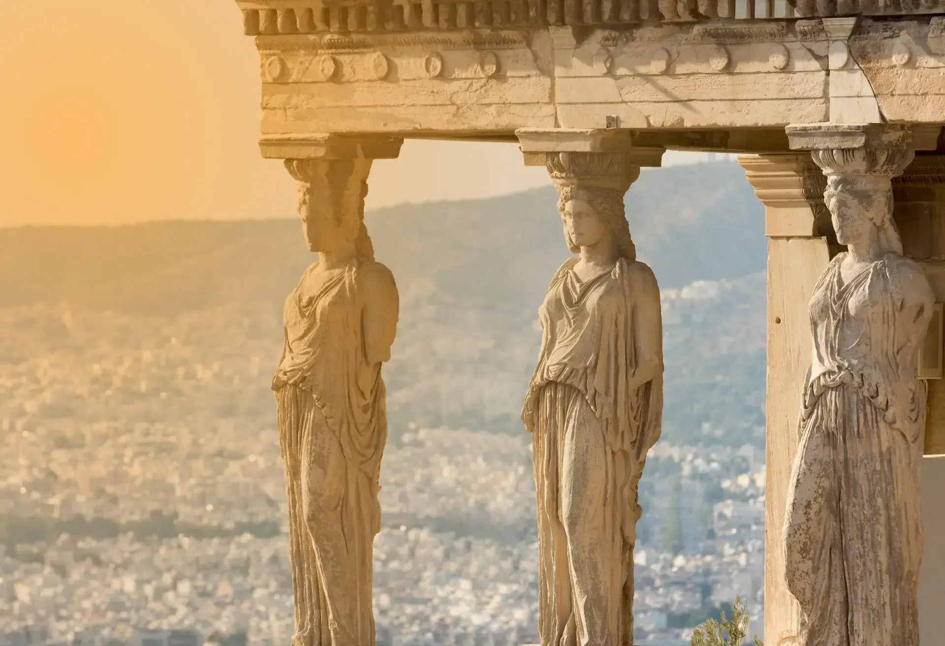 The karyatides statues at sunset inside acropolis of Athens