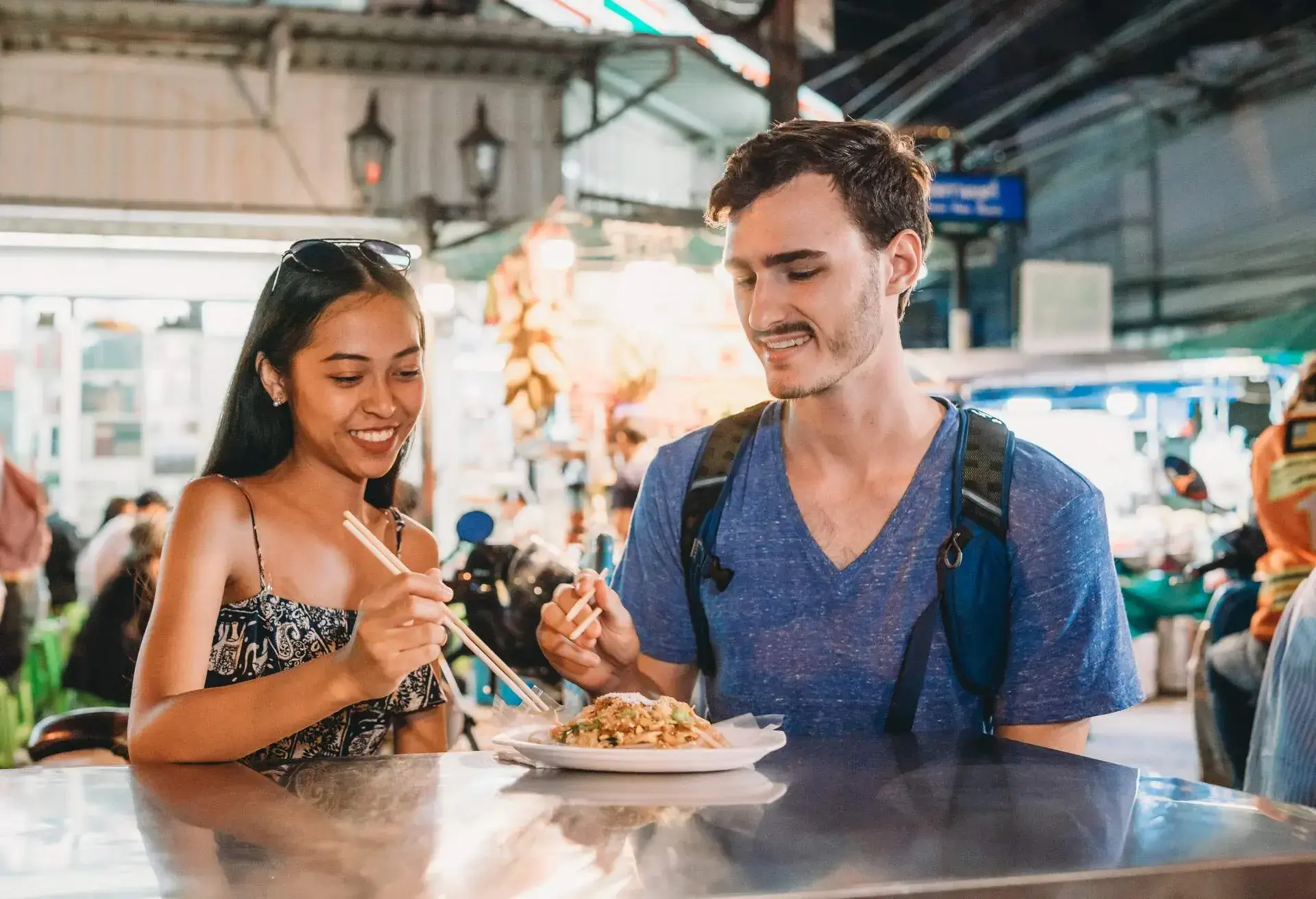 Young couple having dinner together at the night market
