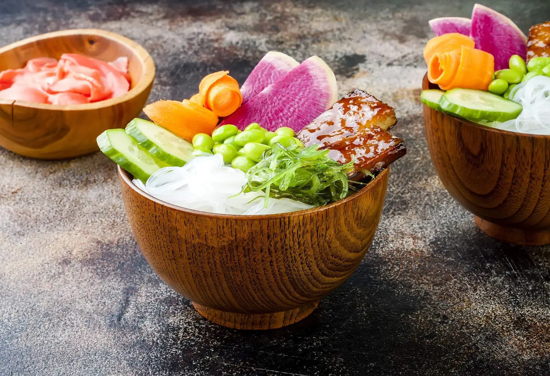 Vegan tofu poke bowls with seaweed, watermelon radish, cucumber, edamame beans and rice noodles. Copy space background; Shutterstock ID 667836874; Purpose: ; Brand (KAYAK, Momondo, Any):