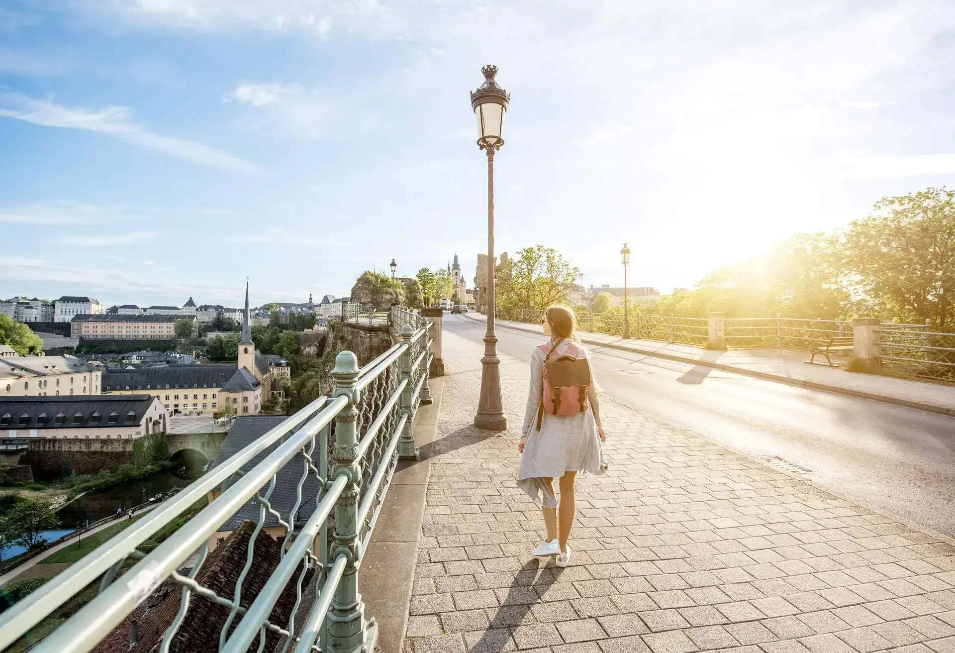 Woman walking on the bridge with great view on the old town of Luxembourg city