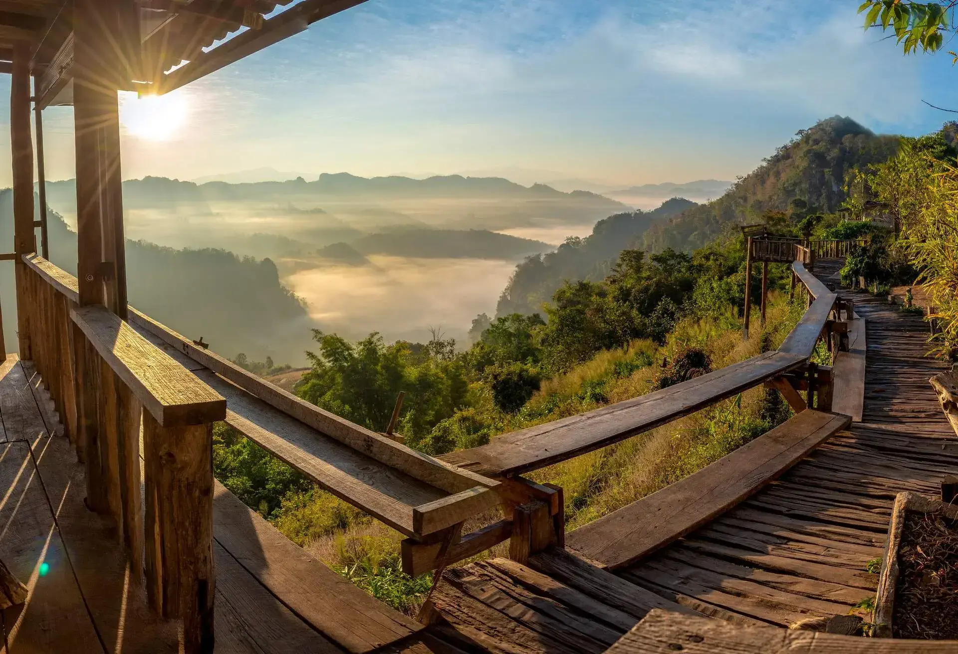 Ban Chobo tribal village with green mountain houses and beautiful fog, blue sky Pang Mapha District, Mae Hong Son Province, Northern Thailand