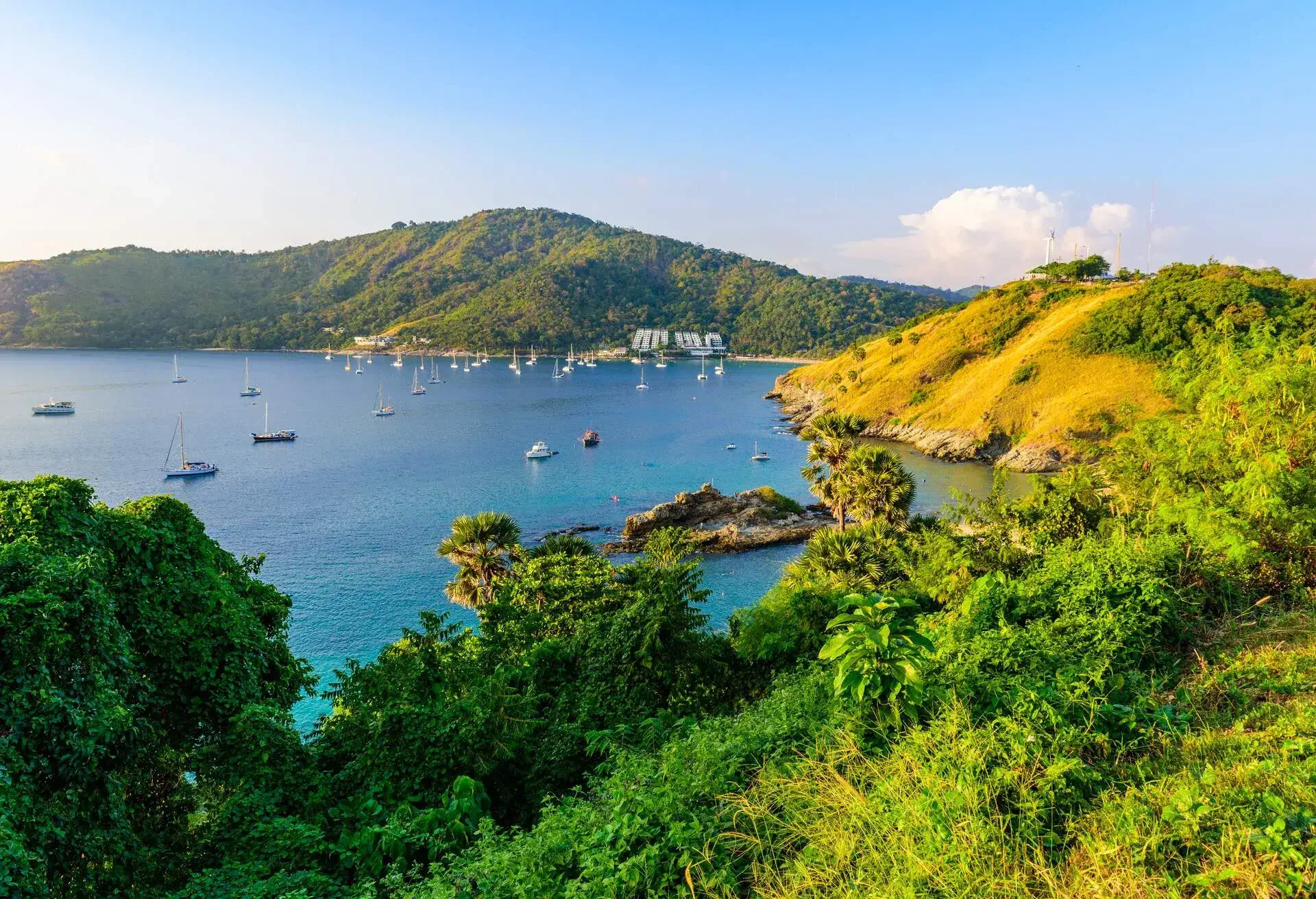 Tropical bay at Naiharn and Ao Sane beach with boats at windmill viewpoint, Paradise destination Phuket, Thailand