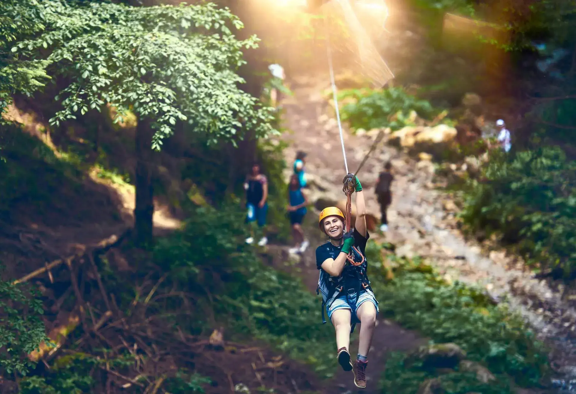 THEME_NATURE_MOUNTAINS_SUMMER_ADVENTURE_ZIPLINE_WOMAN_GettyImages-587549544_Universal