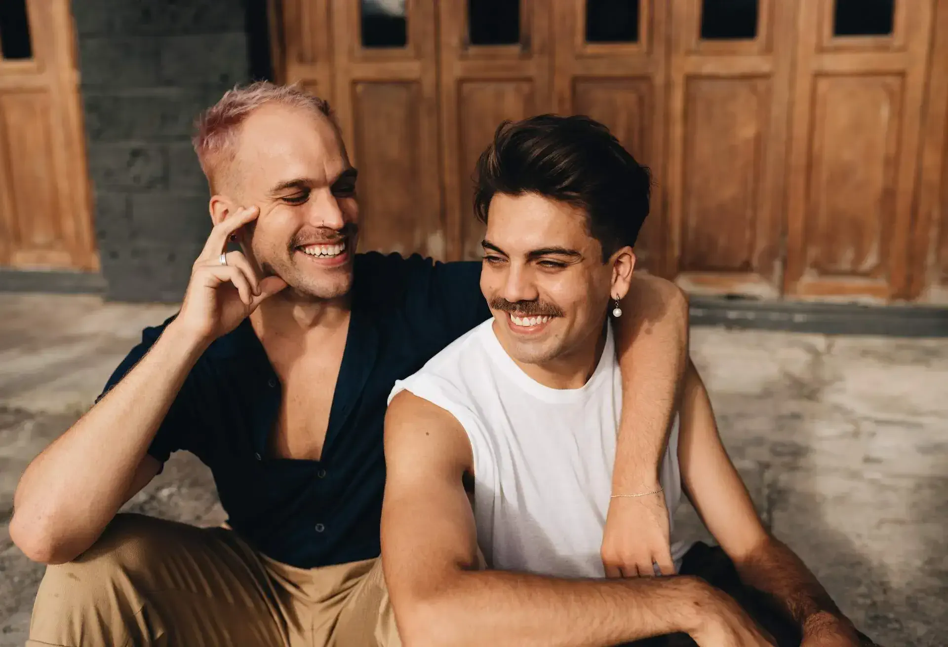 Gay Couple spend time together outdoors. Homosexual couple having fun together