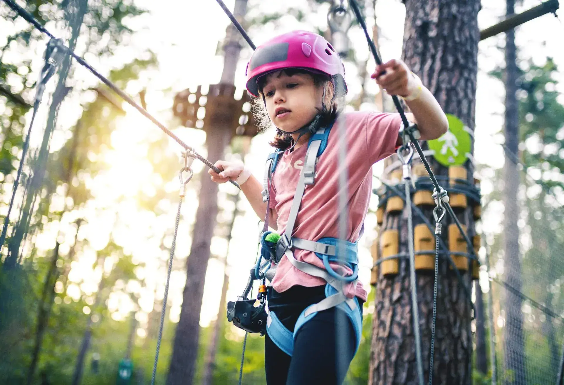 THEME_PEOPLE_KID_GIRL_ADVENTURE_PARK_ZIP_LINE_FOREST_GettyImages-1175052474